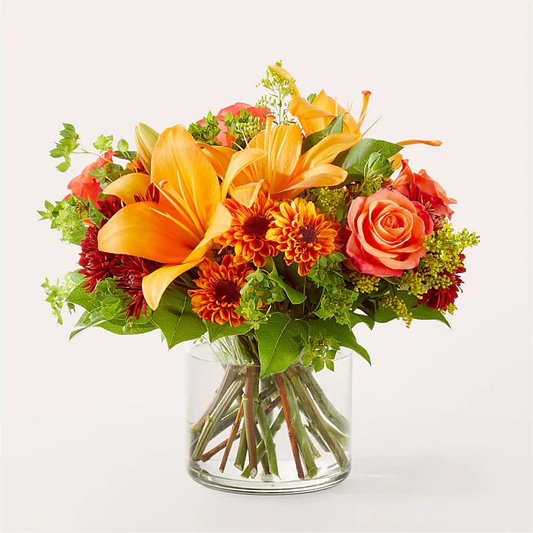 HoneyCrisp Bouquet - Make their day as sweet as a honey crisp apple with this blooming beauty, bursting with pops of orange, red and yellow. The arrangement contains Daisy, Rose, Solidago, Lily