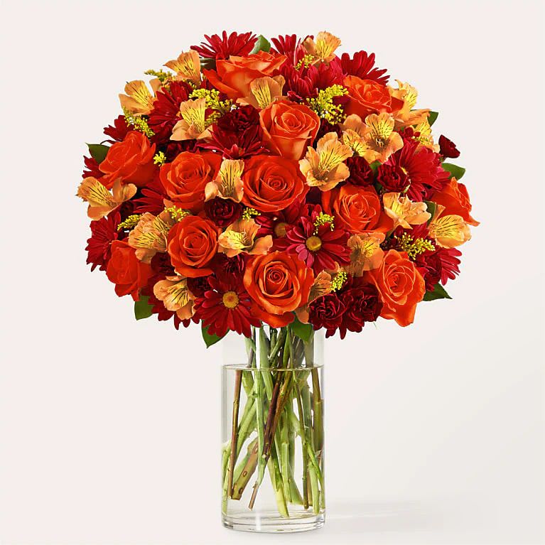 Falling Leaves Bouquet - Celebrate late autumn with these rich tones of orange, red, burgundy and yellow. This arrangement is the perfect end of fall delight to bring the beauty of the season inside. The arrangement contains Rose, Carnation, Solidago, Alstroemeria