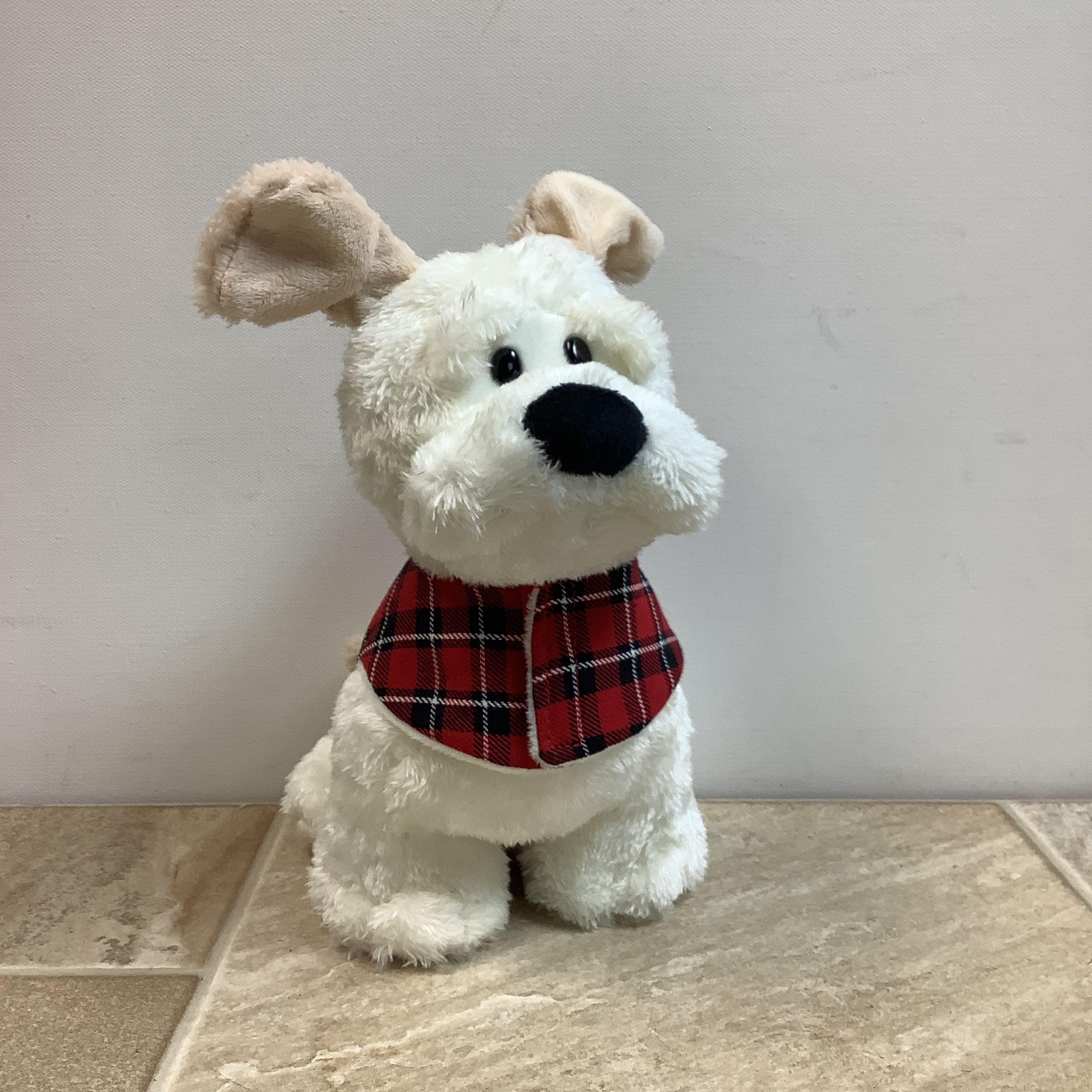 Ralphie plush dog - This fluffy, white plush dog is sure to charm with his floppy, tan ears, black nose and eyes and stylish red and black plaid outfit. Approximate size: 6&quot; wide x 10&quot; high.