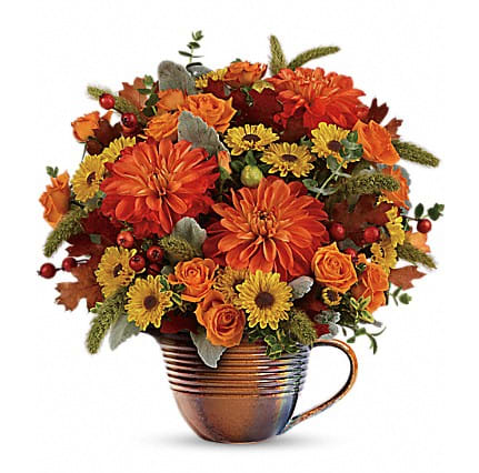 Autumn Sunrise - As glorious as the sunrise, this radiant arrangement of roses, dahlias and mums will brighten any fall table! The lush bouquet is presented in a gorgeous hand-glazed, food-safe stoneware measuring cup that's perfect for displaying fresh flowers next to the turkey - or for pouring gravy on it!
