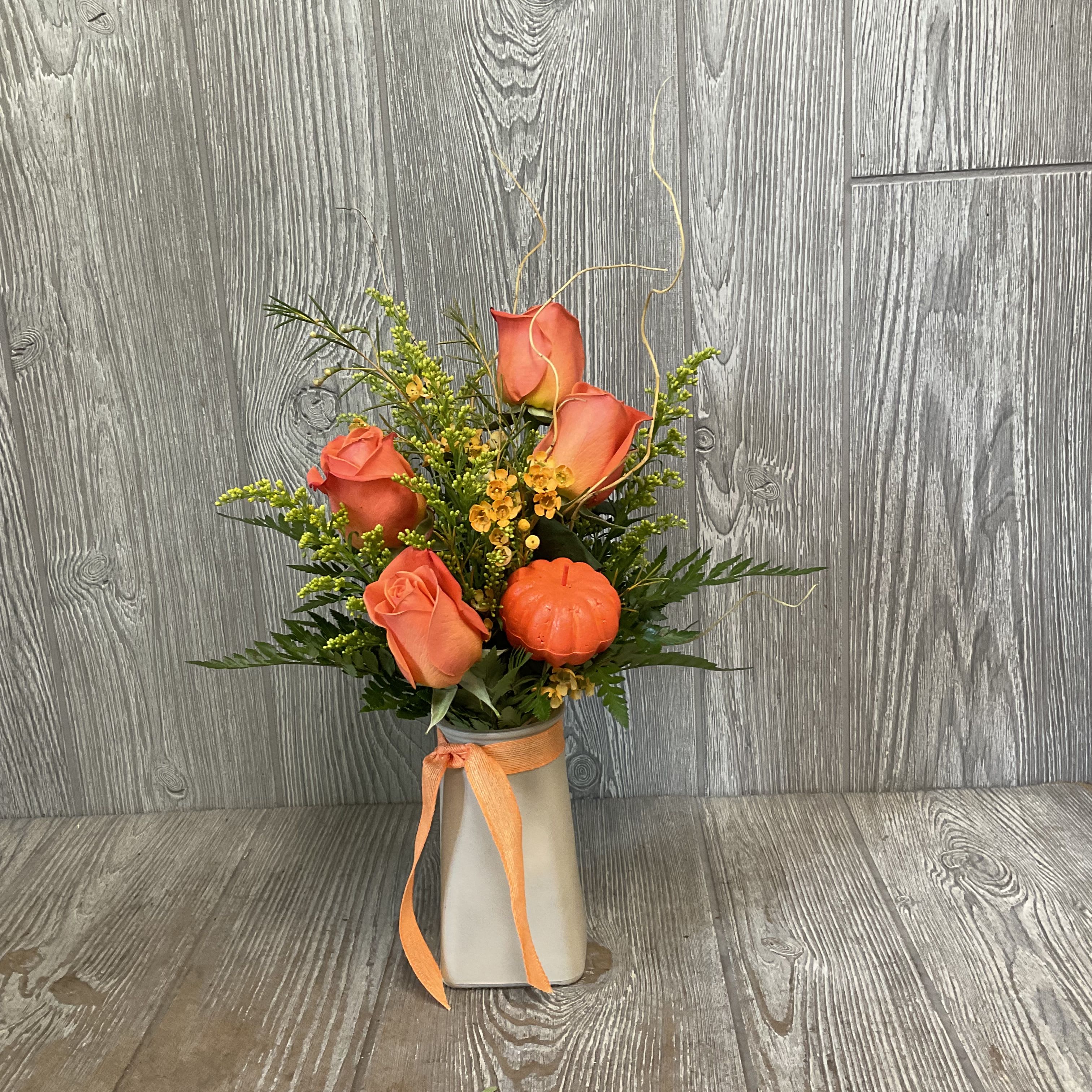 Pumpkin Spice - Perfect for fall, this arrangement contains a variety of orange flowers including roses. This petite arrangement is perfect for a desk or dorm room. Flowers and container may vary. 
