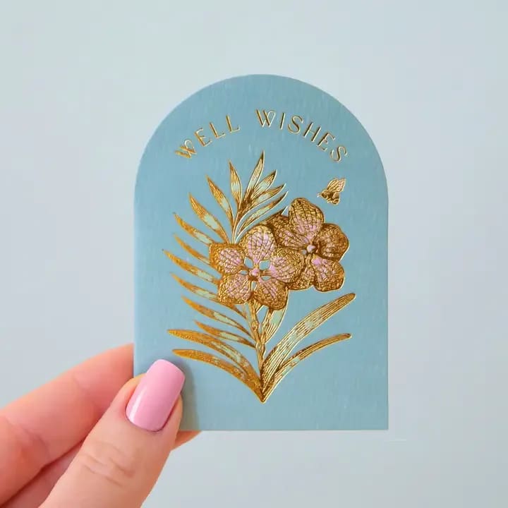 Well Wishes Orchid | Mini Card - Add a touch of beauty and heartfelt well wishes to any gift with our Mini Well Wishes Orchid Card. With elegant colors and gold foil details, this card is sure to show your loved ones how much you care. The perfect addition to any thoughtful present.  .        Size | 2.5 x 3.5 inches .        Gold Foil Stamped  **If you are having us write a personal message, please keep in mind we have limited space to write. Thank you.**