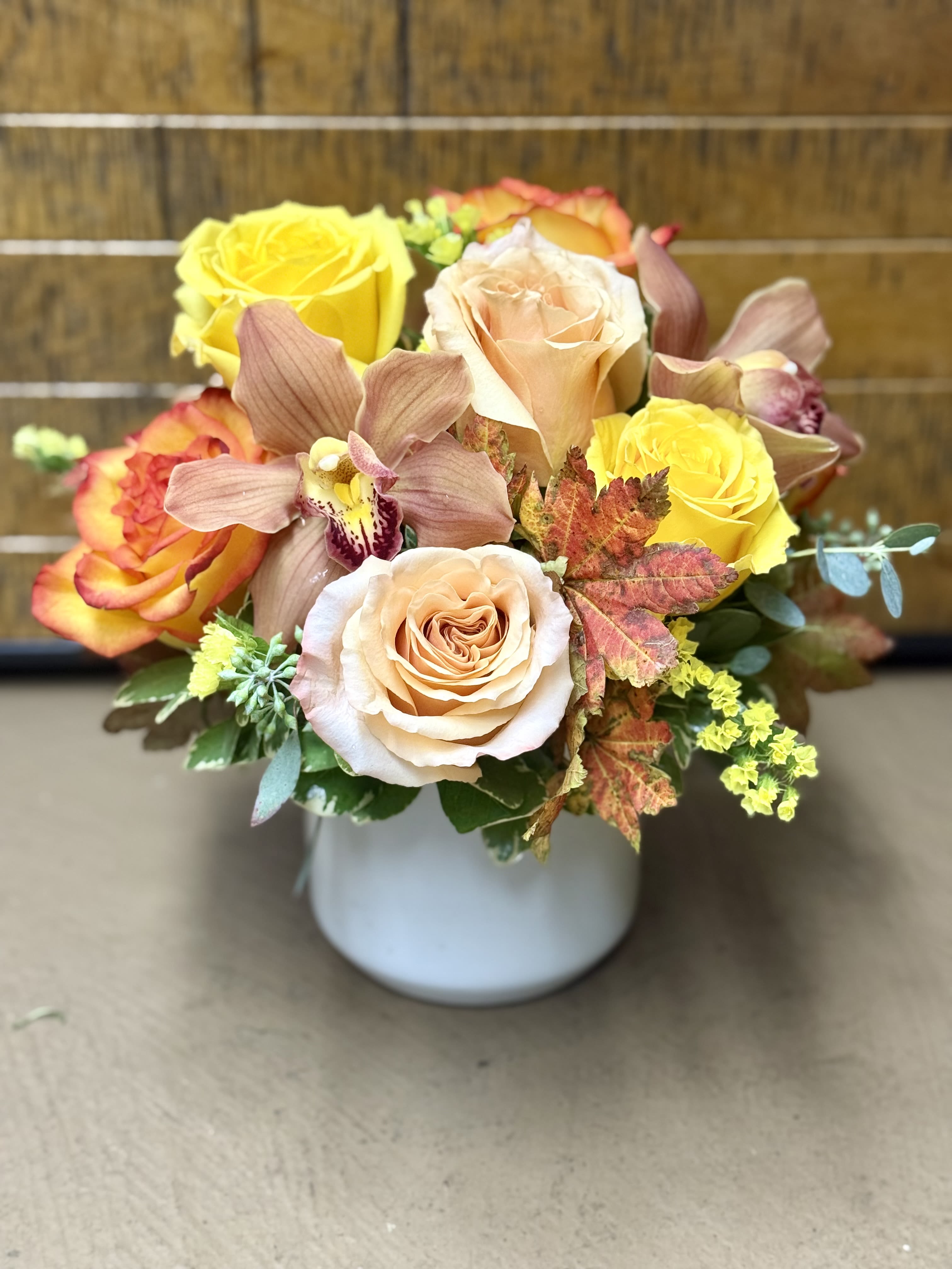 Autumn in San Francisco Autumn in San Francisco - Understated elegance shines in this charming collection of 9 roses, and 3 cymbidium orchids designed in a keepsake ceramic pot. Rose variety may vary