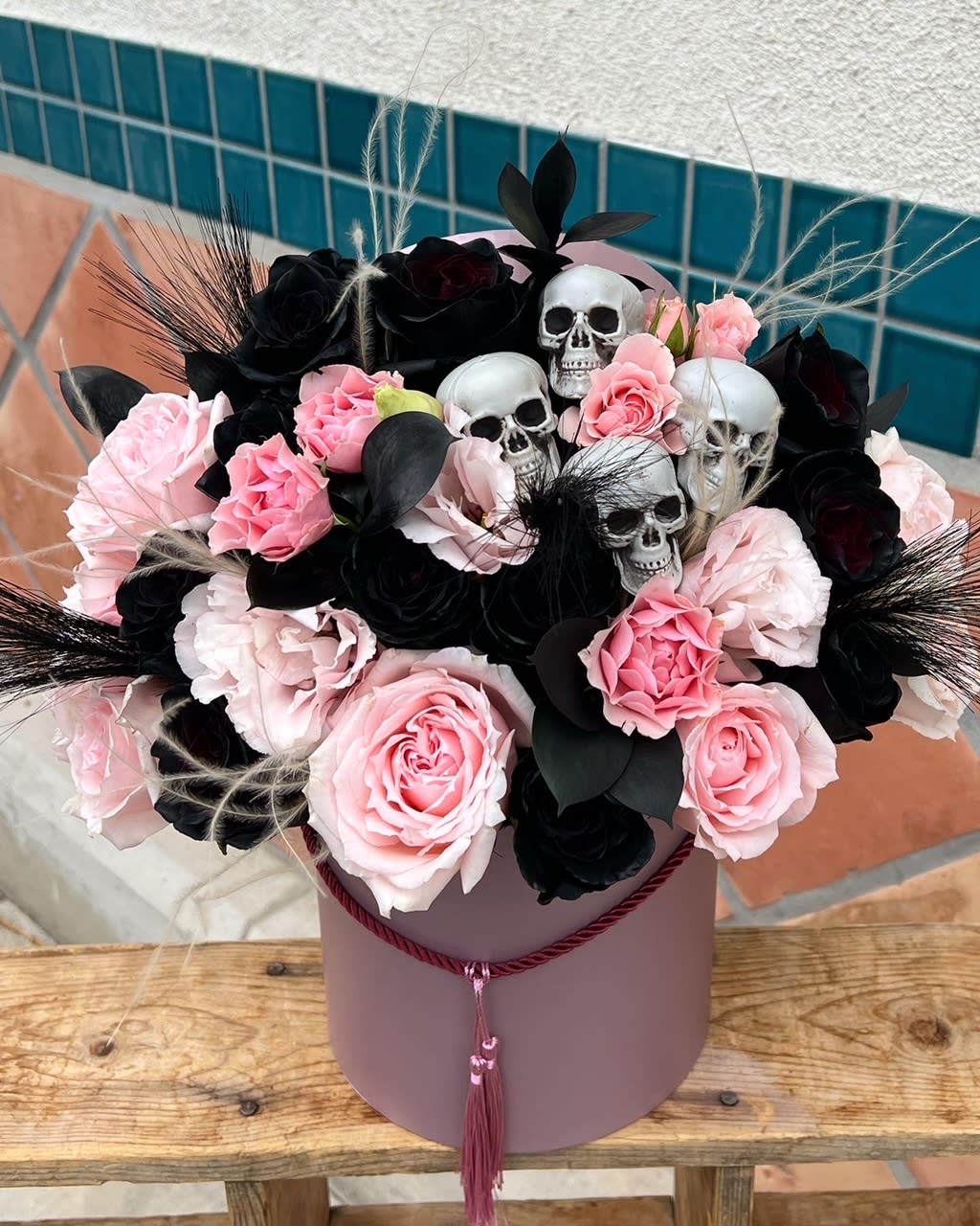 Hey Boo-tiful - pink and black flowers arranged inside a pink flower box. 