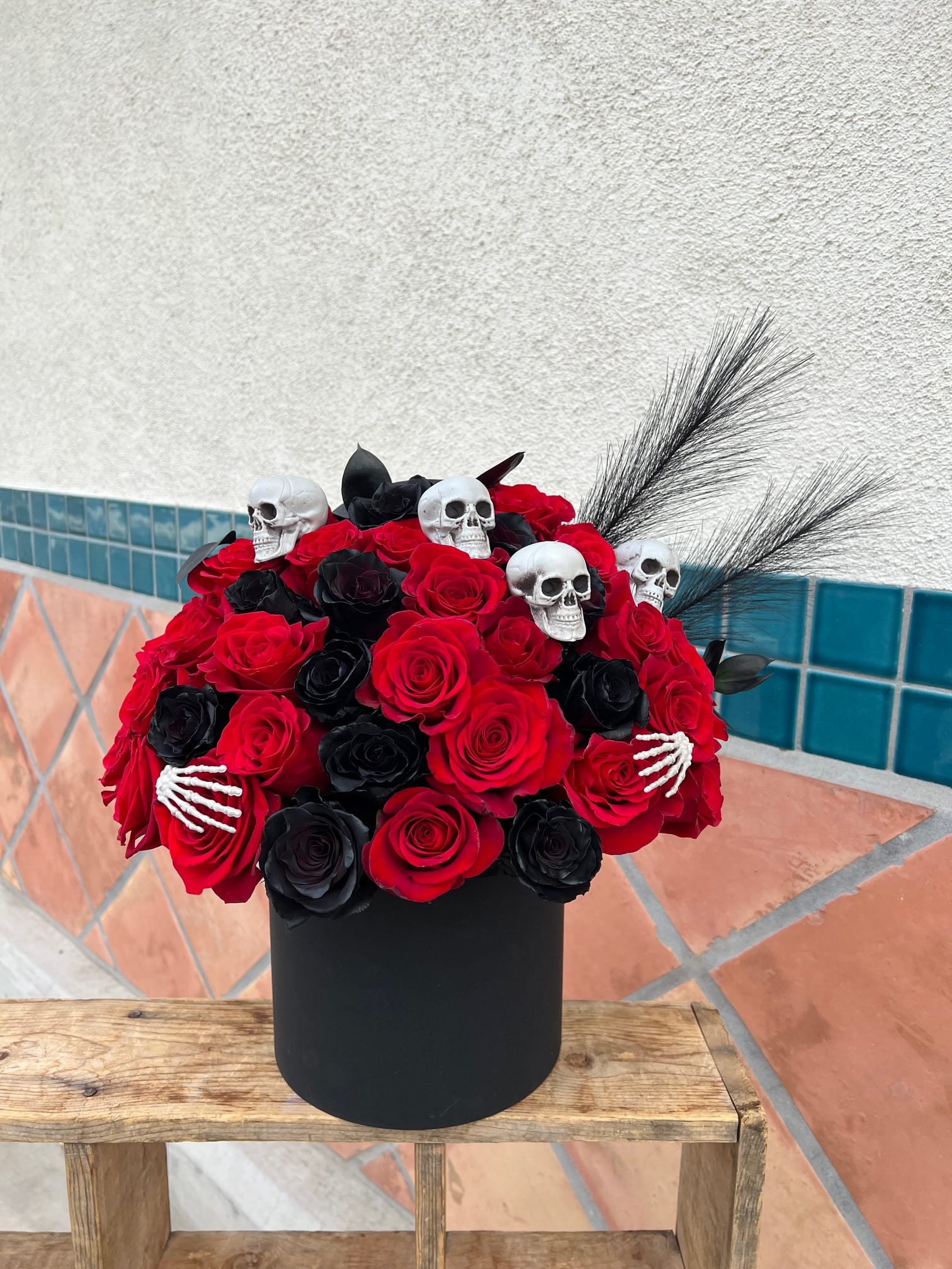 Love you to death - Unleash the dark beauty of Halloween with this hauntingly elegant arrangement of deep red and black roses, artfully displayed in a sleek black flower box. Perfectly moody and mysteriously romantic, this floral display brings a gothic touch to your spooky season decor or makes a dramatic gift for those who love the darker side of beauty. 