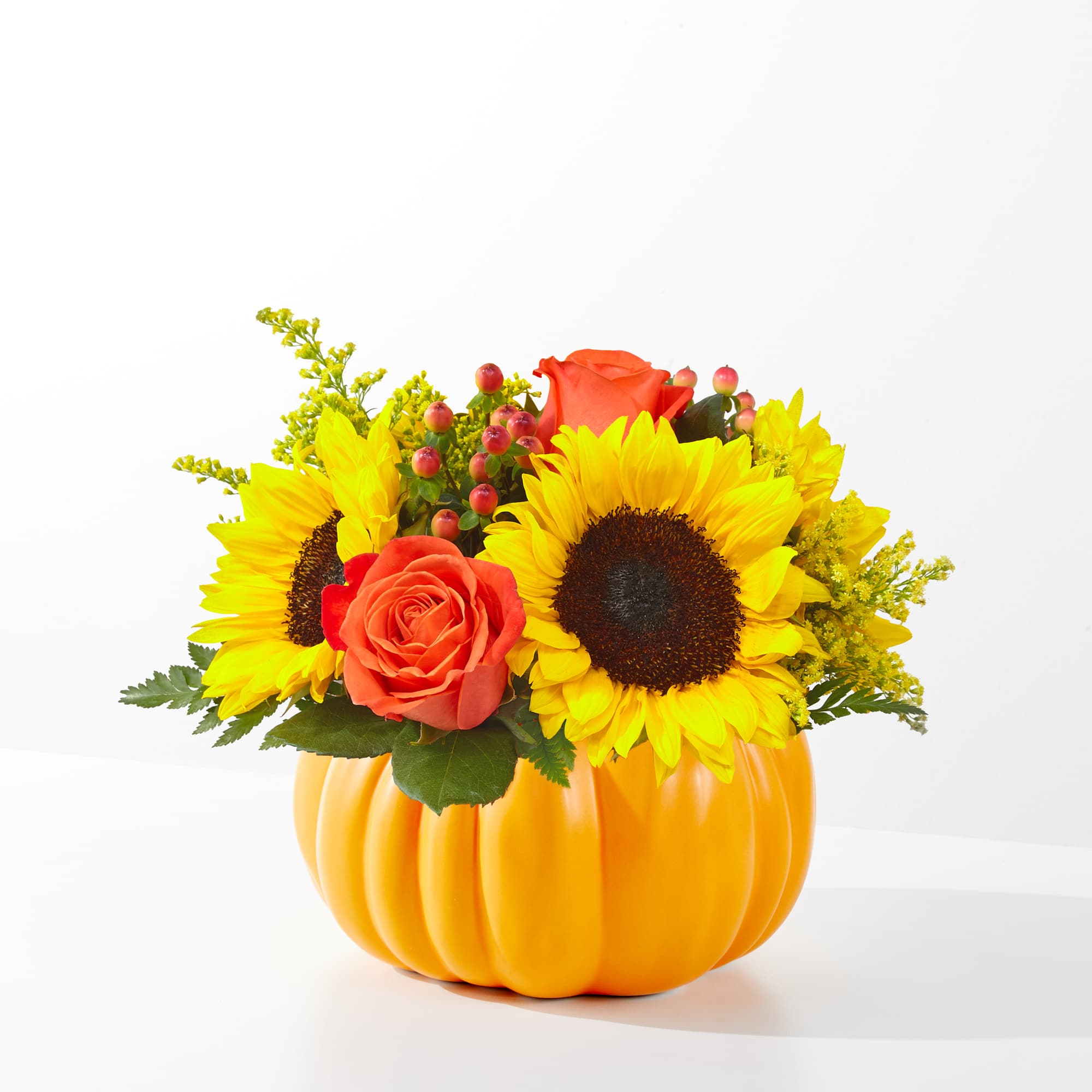 24-F2 PICK OF THE PATCH - Traditional fall flowers in a ceramic pumpkin.  Great fall arrangement for gift giving - can be used as a centerpiece!
