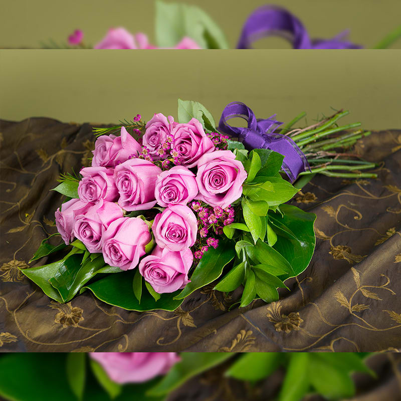 Cher - Lavender Roses Hand Tied Cher - Lavender Roses Hand Tied - Our exquisite imported Ecuadorian roses are what we are known for here at Andes. Hand-tied with quality greens and fillers, this presentation is a classic.