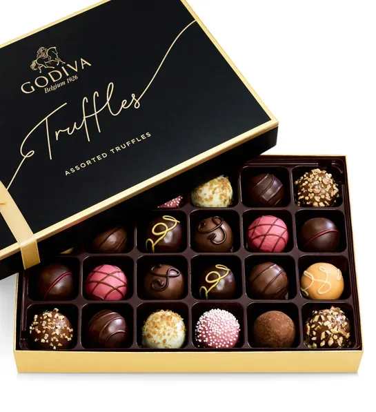 50% off! Godiva 24pc Signature Truffle  - GODIVA Signature Truffles 24-Piece Gift Box  Surprise your special someone with an elegant gift box filled with their favorite treat—luscious chocolate truffles. Crafted by GODIVA Chef Chocolatiers, this 24-piece Signature Truffles gift box offers a luxurious selection of milk, dark, and white chocolate truffles, perfect for indulging in sublime flavors and textures.  Key Features:  24-Piece Assortment: A sophisticated mix of milk, dark, and white chocolate truffles. Perfect for Any Occasion: Ideal for birthdays, Valentine’s Day, holidays, or any special moment. Elegant Presentation: Each box is beautifully finished with a red snap bow, making it a stunning gift. Box Dimensions: 9.96&quot; W x 1.66&quot; D x 6.81&quot; H. Components may vary. Share the luxury of GODIVA's finest truffles with anyone who appreciates exquisite chocolate.