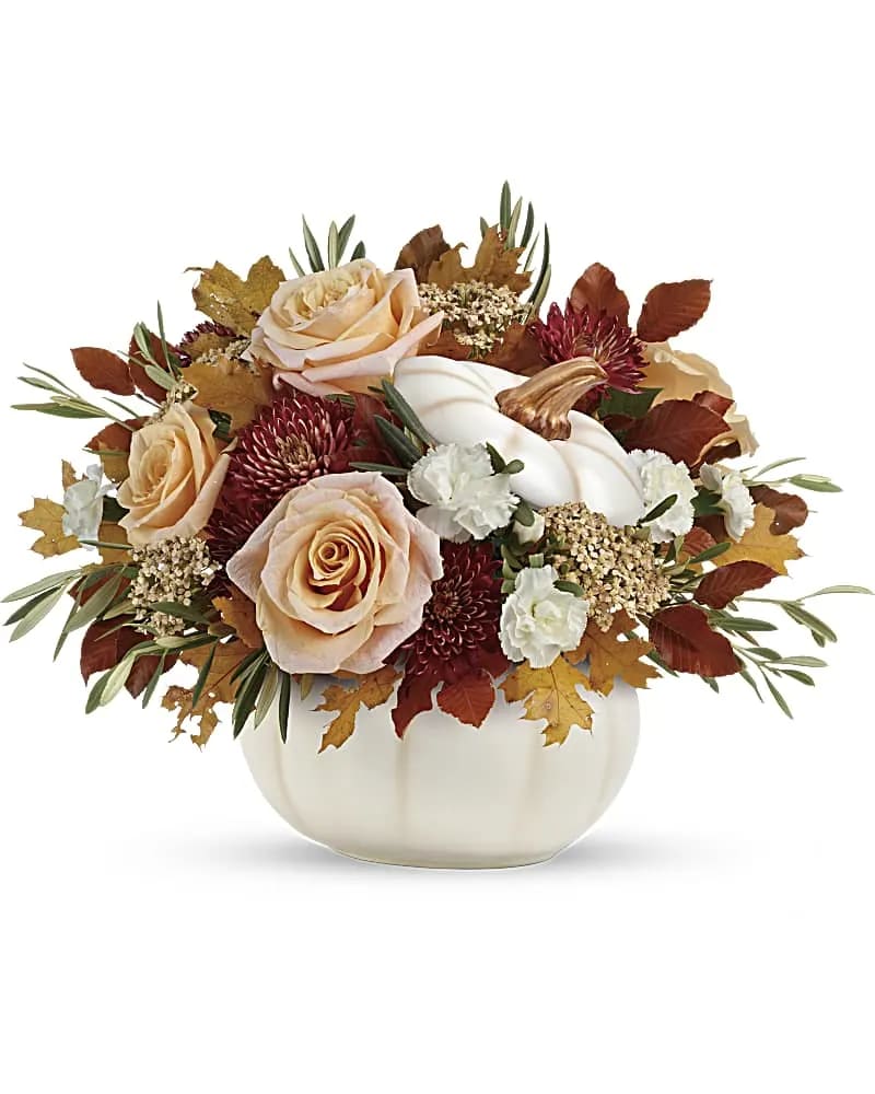 Harvest Charm Bouquet - Elegant crème roses blend with the heartwarming hues of autumn in this charming bouquet, artfully arranged in a white lidded pumpkin bowl, a versatile fall decor favorite! This charming arrangement features crème roses, white miniature carnations, burgundy cushion spray chrysanthemums, yellow cottage yarrow, olive, and brown copper beech. Delivered in an Enchanted Harvest Pumpkin