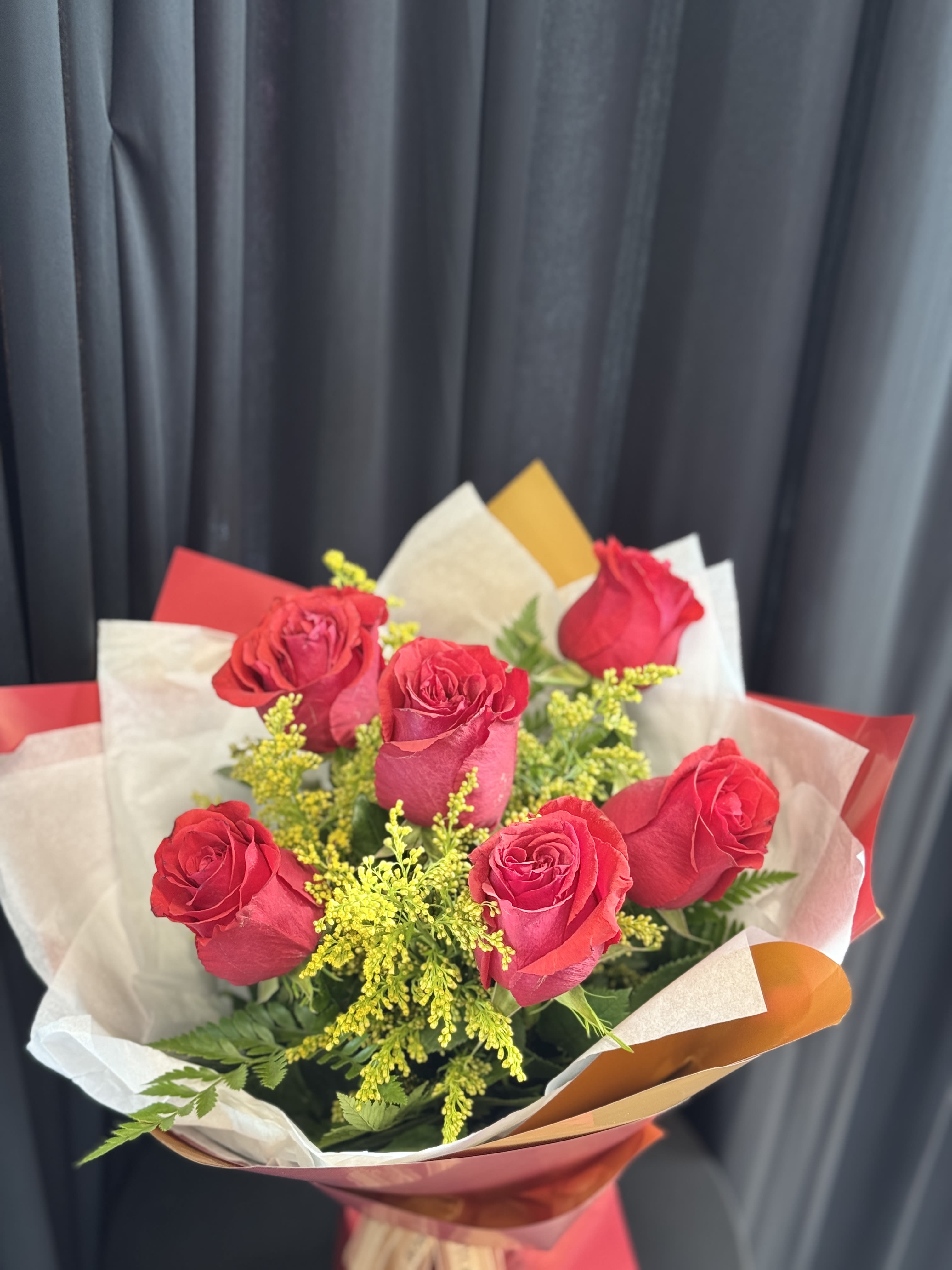 Half Dozen Red Roses With Wrap  - In some instances, our photo may represent an overall theme or look and include a one-of-a-kind vase which cannot be exactly replicated.  Although the actual bouquet may not precisely match the photo, its temperament will. Occasionally, substitutions of flowers and/or containers happen due to weather, seasonality and market conditions which may affect availability. If this is the case with the gift you’ve selected, we will ensure that the style, theme and color scheme of your arrangement is preserved and will only substitute items of equal value or higher value.  If any design elements are of major importance to your order, please include them in the florist instructions at checkout or contact us to ensure availability.