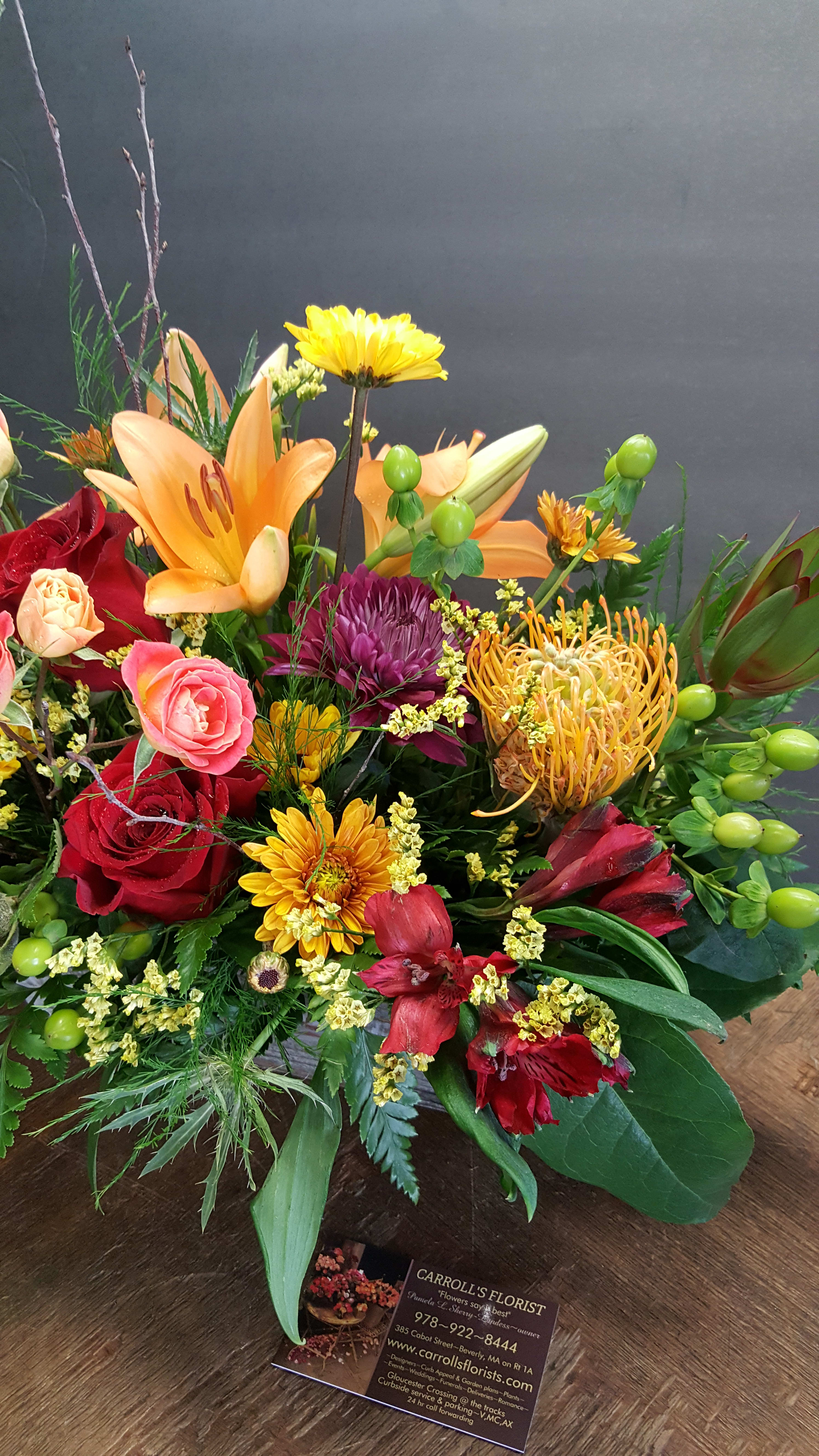 Kearsage Kearsage - SEASONAL theme....Colorful & bright..Mixed flowers based on in stock variety & season. co Other varieties of floral's will be used in this design. PLEASE NOTE!!! LIMITED qty of in stock box containers. Can always design an oblong in low wicker too! Upgrade to DELUXE to add roses, LIMITED! Pin cushions, Lily & Sunset Safari, ALL May need to sub out for other floral's & colors. Call 978 922 8444 to discuss!