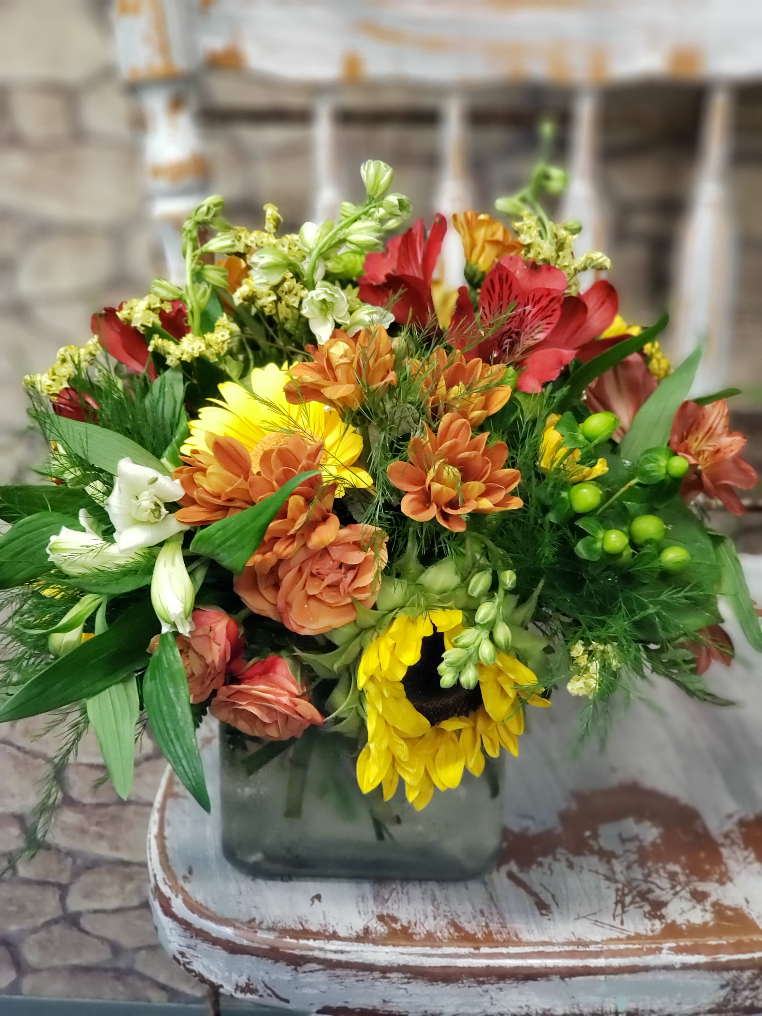 Autumn Breeze Autumn Breeze - Cube, cylinder glass vase of mixed colors & blooms. Photo sample is for size & style only! Please note when ordering a 1st & 2nd choice of color theme. Colors & flowers will vary!
