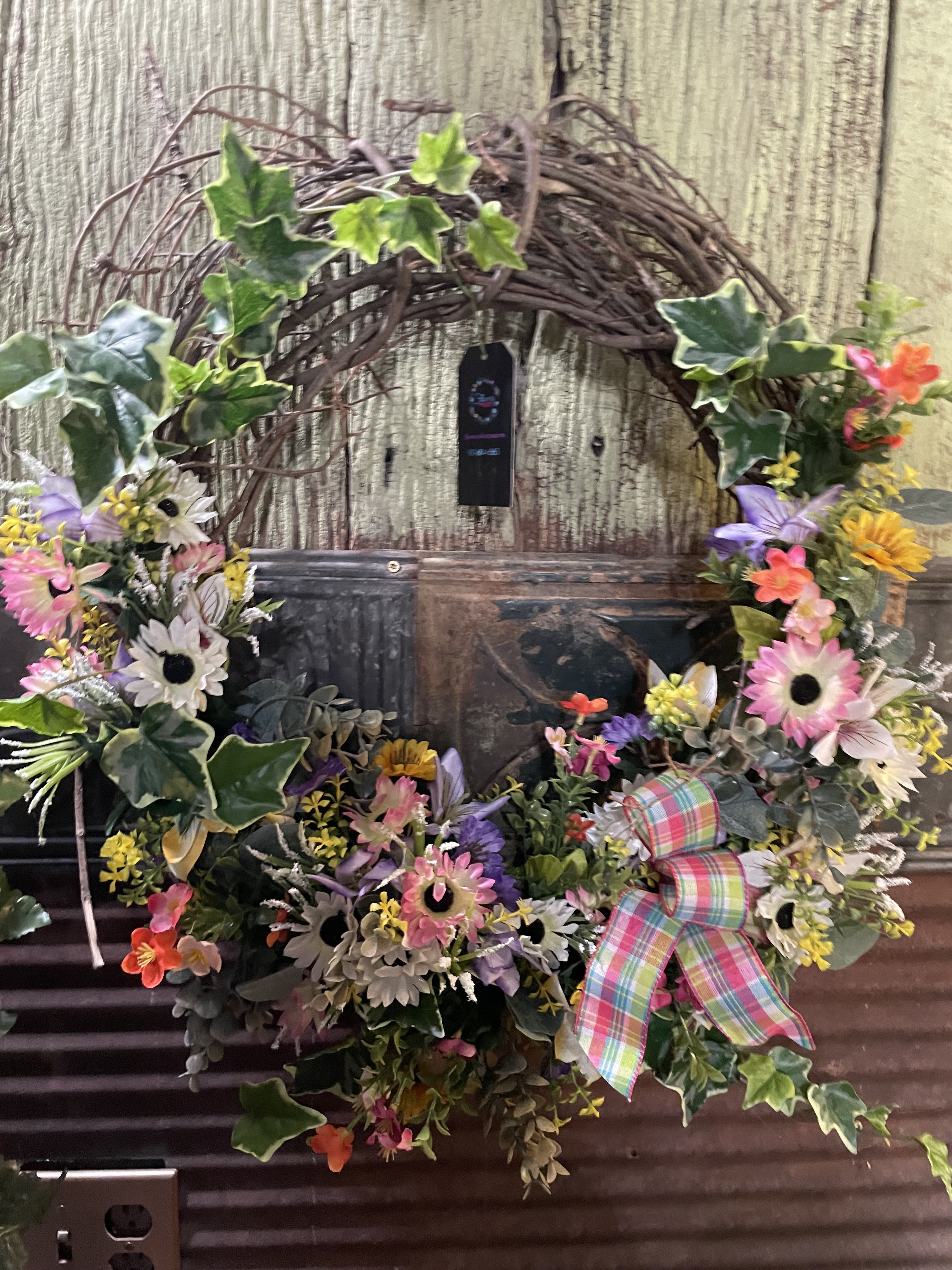 Sweet Days Grapevine Wreath - Get ready to welcome friends with this wreath upon your front door. Designed with mixed greens and daisies, plaid ribbons