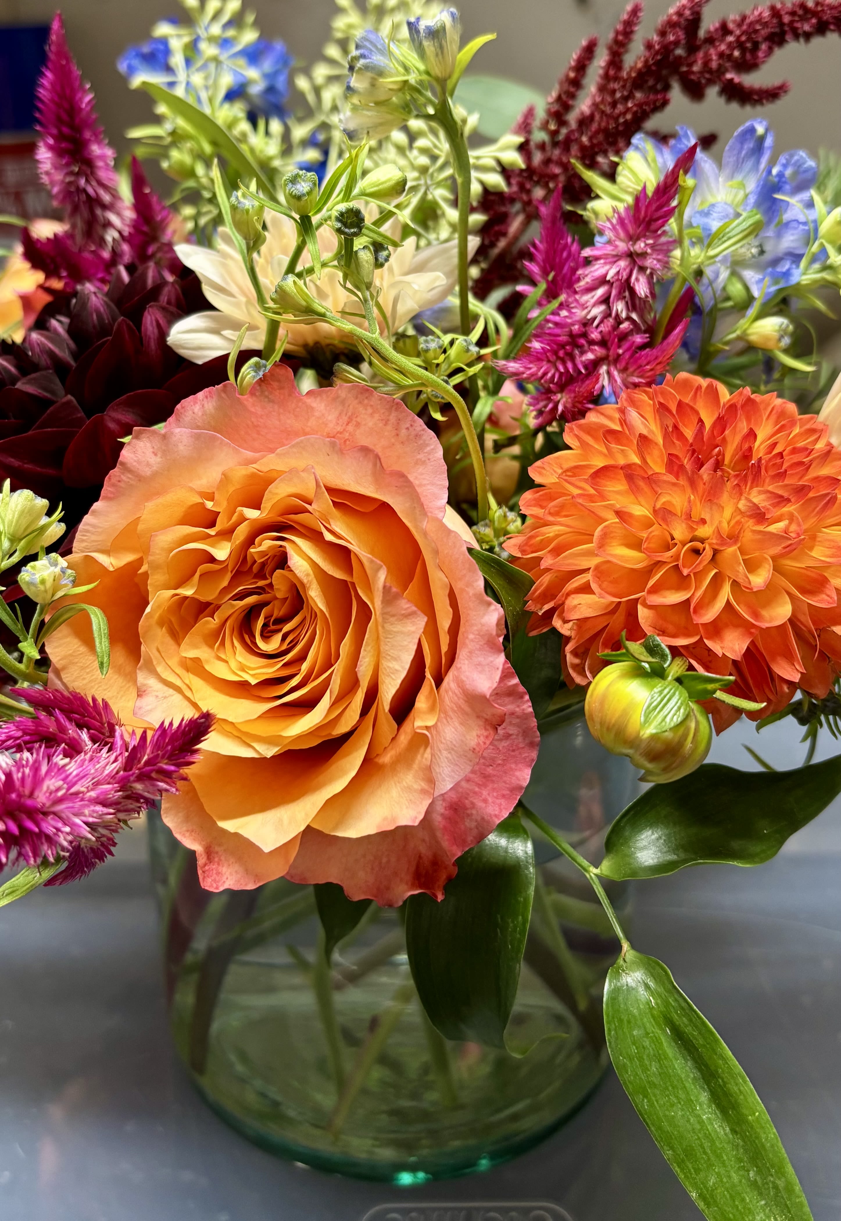 Eva Eva - If you are looking for a bright and cheerful arrangement look no further than this beautiful centerpiece. Flowers will be hand selected and arranged beautifully in a recycled glass vase. To make it more interesting all flowers will be designer’s choice and sure to make a statement. Every effort will be made to recreate your chosen design. Please note that from time to time due to product availability and quality we may need to make substitutions. We will make sure to keep the original design in mind when making substitutions.