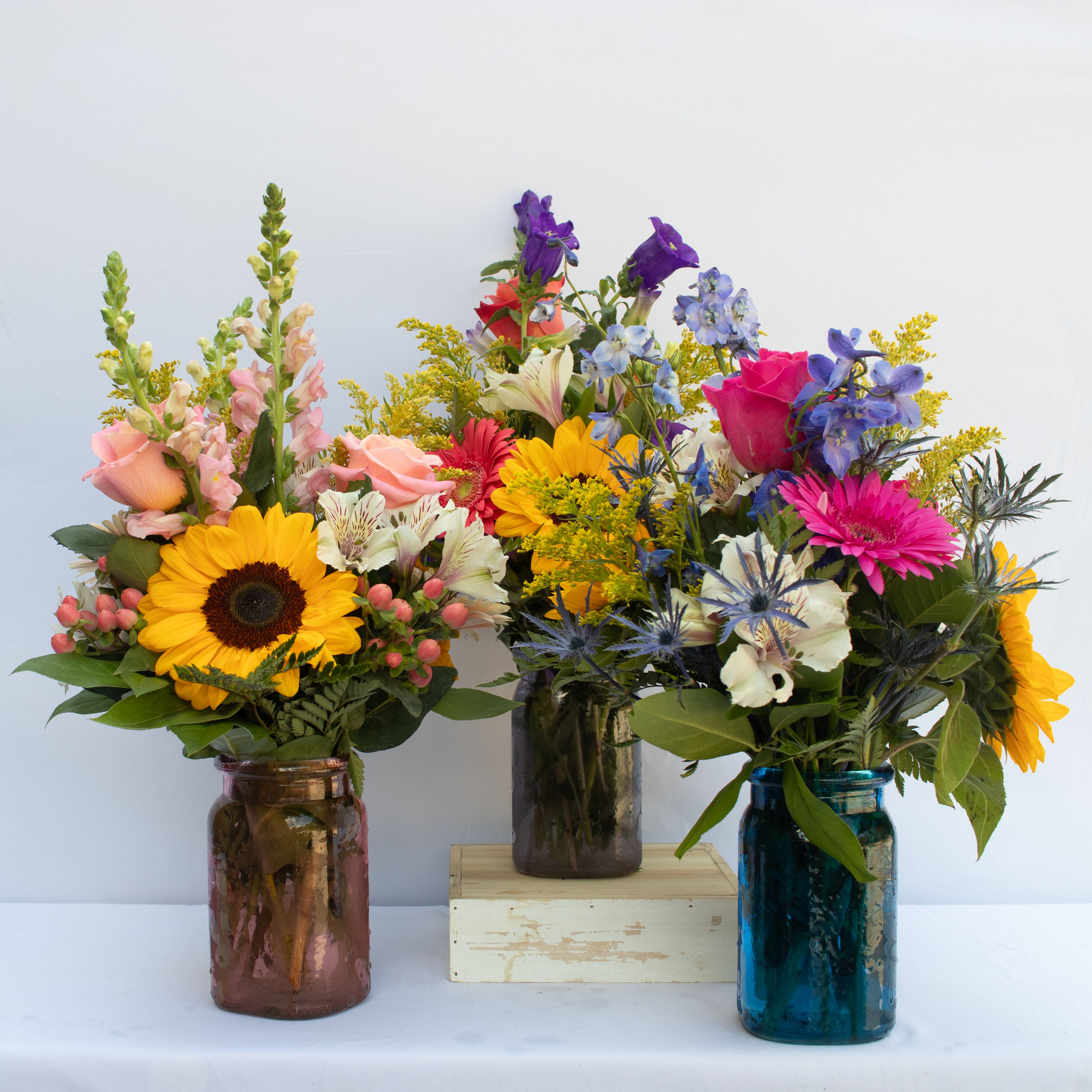 Weekly Farmer's Bouquet  - This is a local floral seasonal bouquet designed for that just picked from your garden look in a 6.5  muted colored hammered glass vase.  Changes weekly as the season changes.   