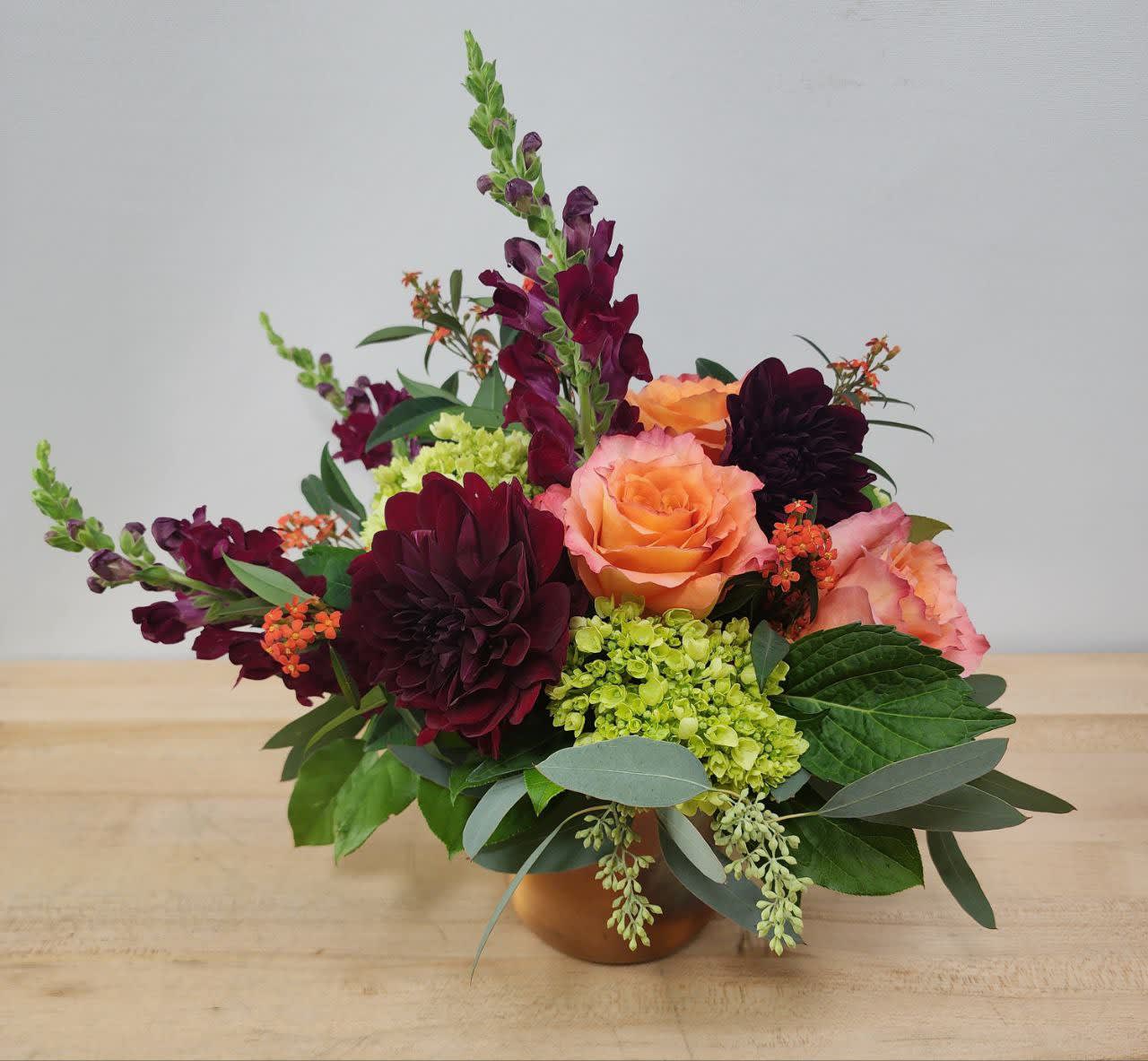 Fall Spirit Fall Spirit - Fall in love with the season's change with beautiful burgundy dahlias and snapdragons paired with fragrant free spirit roses in a unique copper vase. This arrangement is the perfect introduction to fall and appropriate for any occasion.