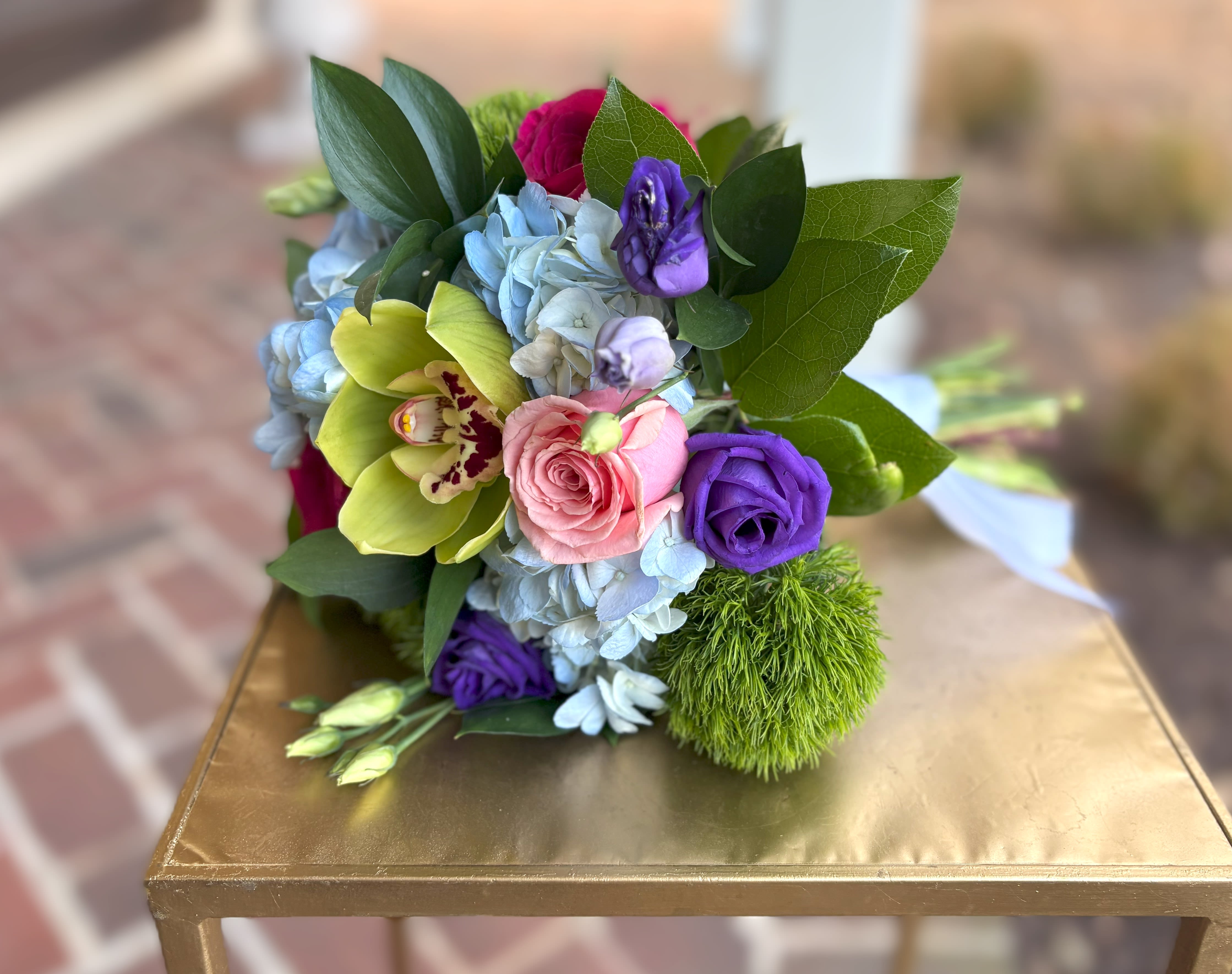 A Pop of Spring Bouquet  - This beautiful spring handheld includes blue hydrangea, dark and light pink roses, purple lisianthus and a green orchid Tax free. Same day hand delivery.  We are a local florist in Wilmington, Delaware that provides the best delivery of fresh flowers on the same day. We also offer next day delivery. Our flower shop services the Wilmington and Newark Delaware areas as well as south eastern PA. We are a flower shop near you that is tax free and provides hand delivered flowers. We offer funeral, sympathy, anniversary, birthday, holiday, Mother's Day, Valentine's Day and rose arrangements and flowers for all occasions. Petals is a full service florist that offers the best online flowers and fresh flower arrangements. You can send flowers from our flower shop to Wilmington, New Castle, Newark, Hockessin, Chadds Ford, Kennett Square and other local cities near us. 