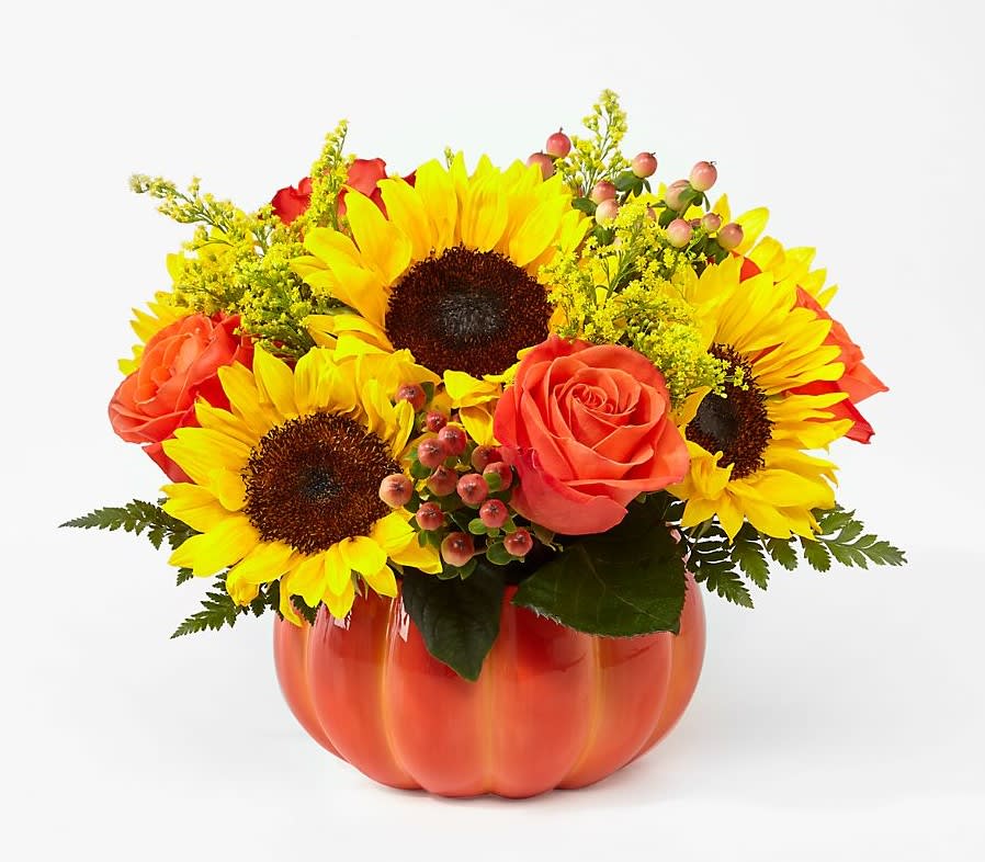 Harvest Traditions - Fun and fresh, this arrangement is perfect for Fall. This ceramic pumpkin is full of vibrant blooms and accents of lush greens.