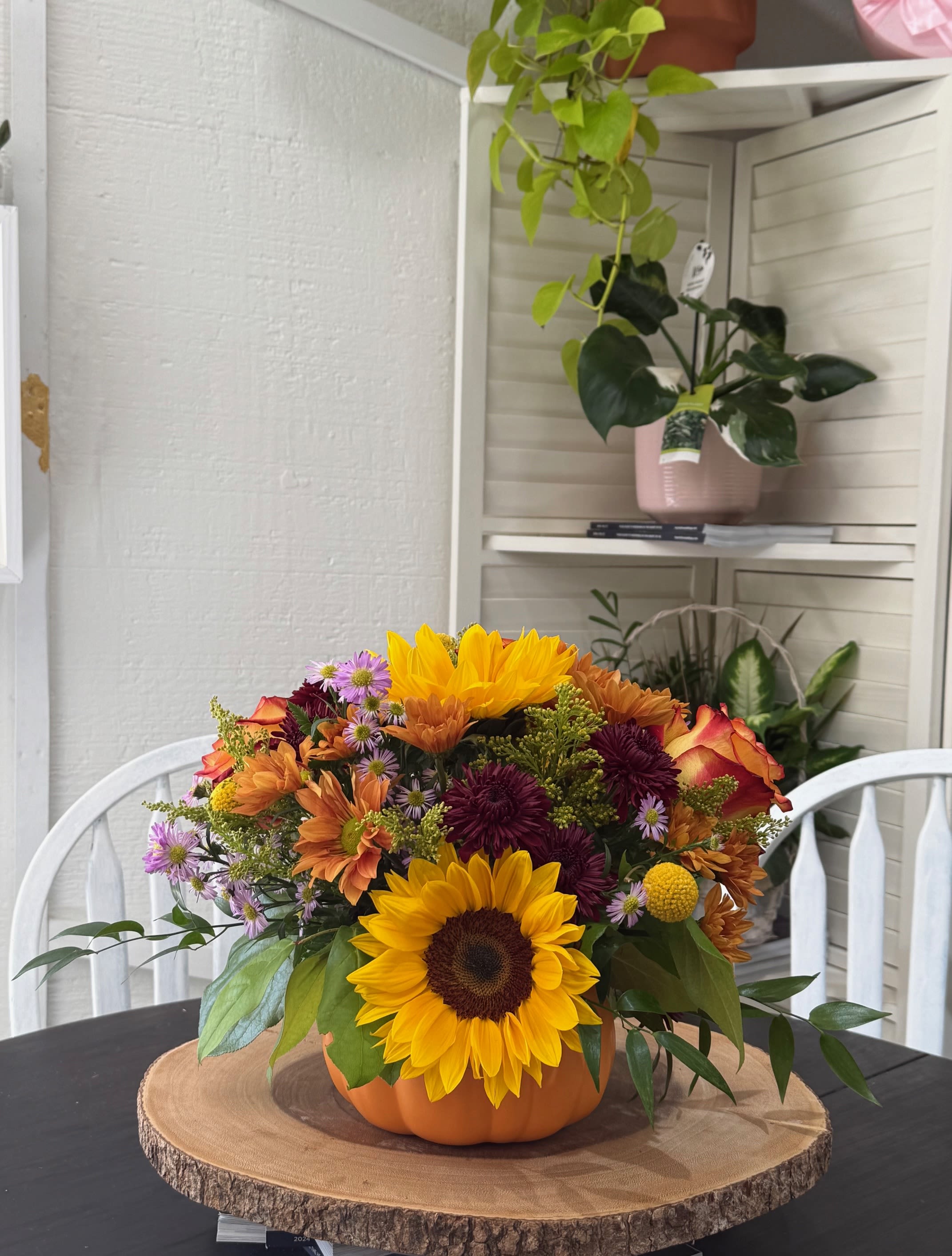 Pumpkin Harvest  - Bring the charm of the pumpkin patch home with this gorgeous fall arrangement. Bursting with seasonal blooms and artfully designed in a keepsake pumpkin vase, it’s the perfect way to share autumn’s glow and brighten someone’s day.