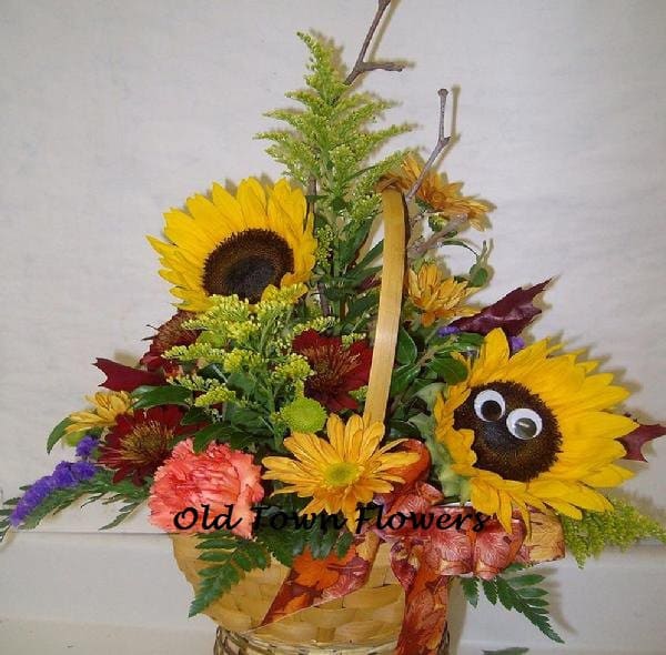 Happy flowers - Sunflowers with peeping eyes, carnations, mums in a basket bound to make you smile