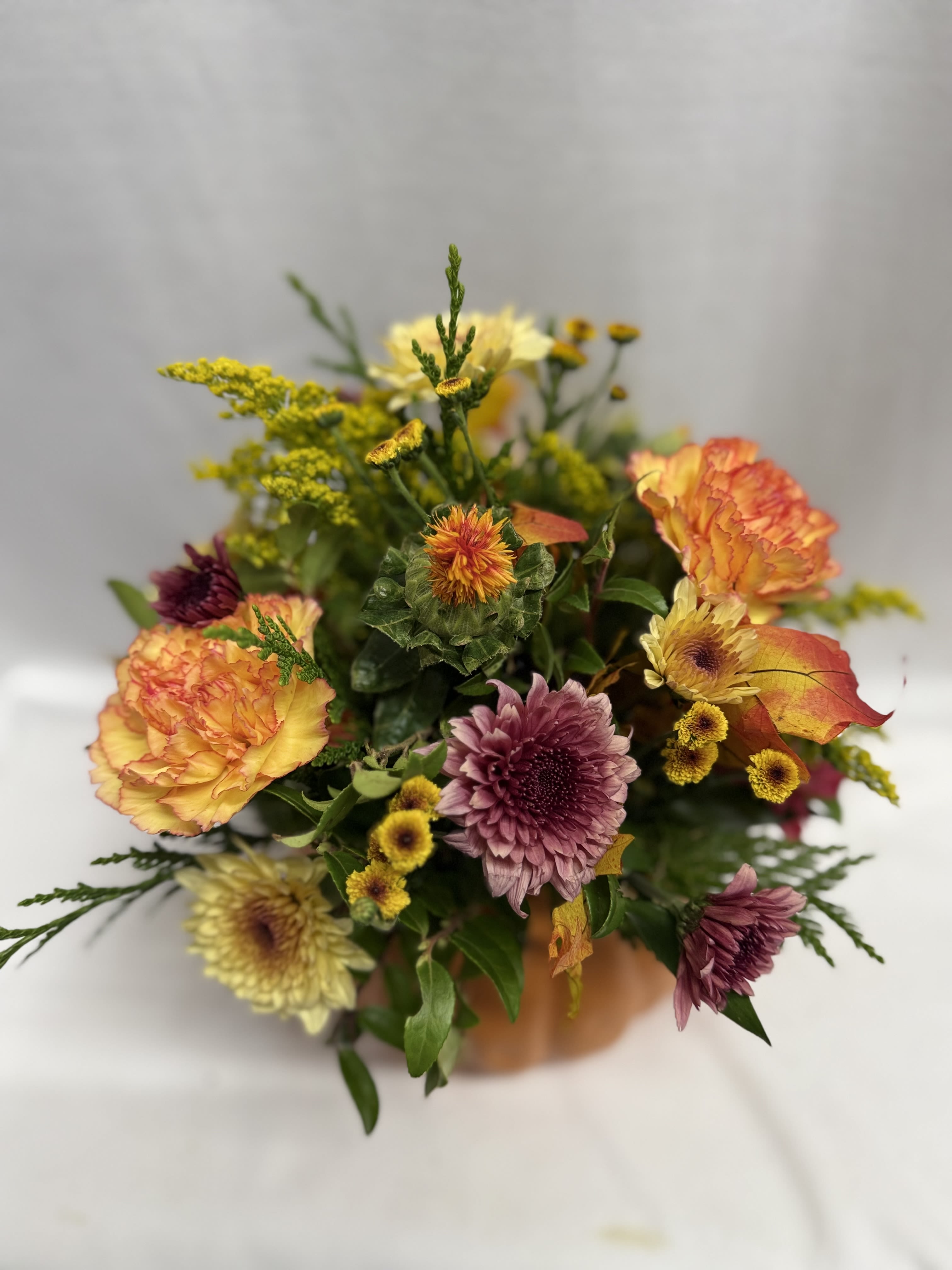 Pumpkin Power by BloomNation™ - Combine your Flower Power with Pumpkin Power with this wonderful, dare we say “powerful,” seasonal arrangement. Housed in a ceramic pumpkin vase, you will surely “fall” in love with this collection of fall flowers this fall. punpkin styles vary. can be used as a candy bowl after the flowers have faded