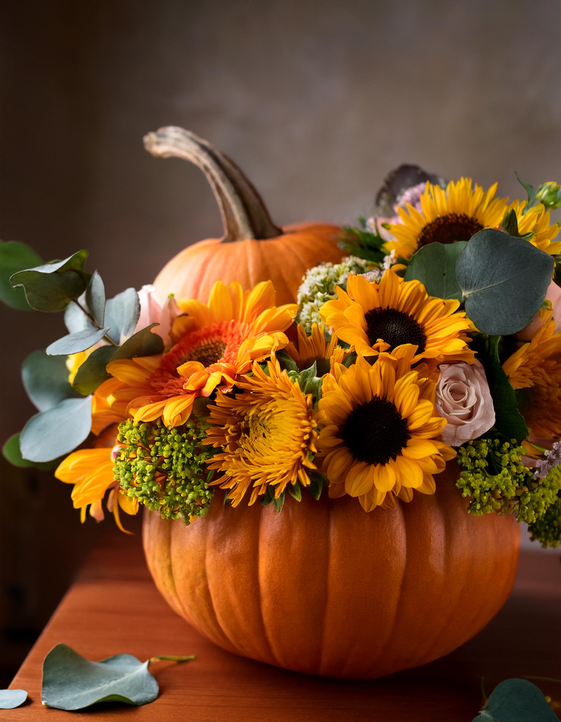 Autumnal Pumpkin Elegance Autumnal Pumpkin Elegance - Add a touch of sophistication to your fall festivities with our Autumnal Pumpkin Elegance. This arrangement features a mix of autumnal flowers and foliage, artfully presented in a stylish pumpkin. Perfect for creating a warm and inviting atmosphere.