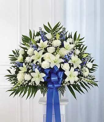Gentle Tribute Gentle Tribute - Timeless and sophisticated lush arrangement showcases lilies complemented by airy white flowers. A perfect arrangement for a service or gesture of support.