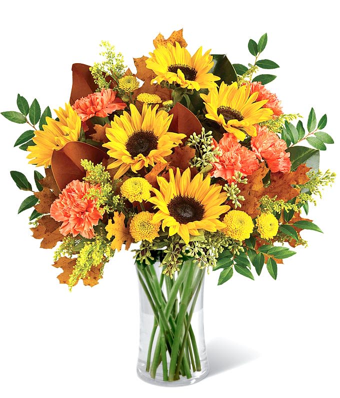 Sunflower Fields - A large vibrant fall floral arrangement featuring golden sunflowers, orange carnations,  and assorted green and fall fillers. 