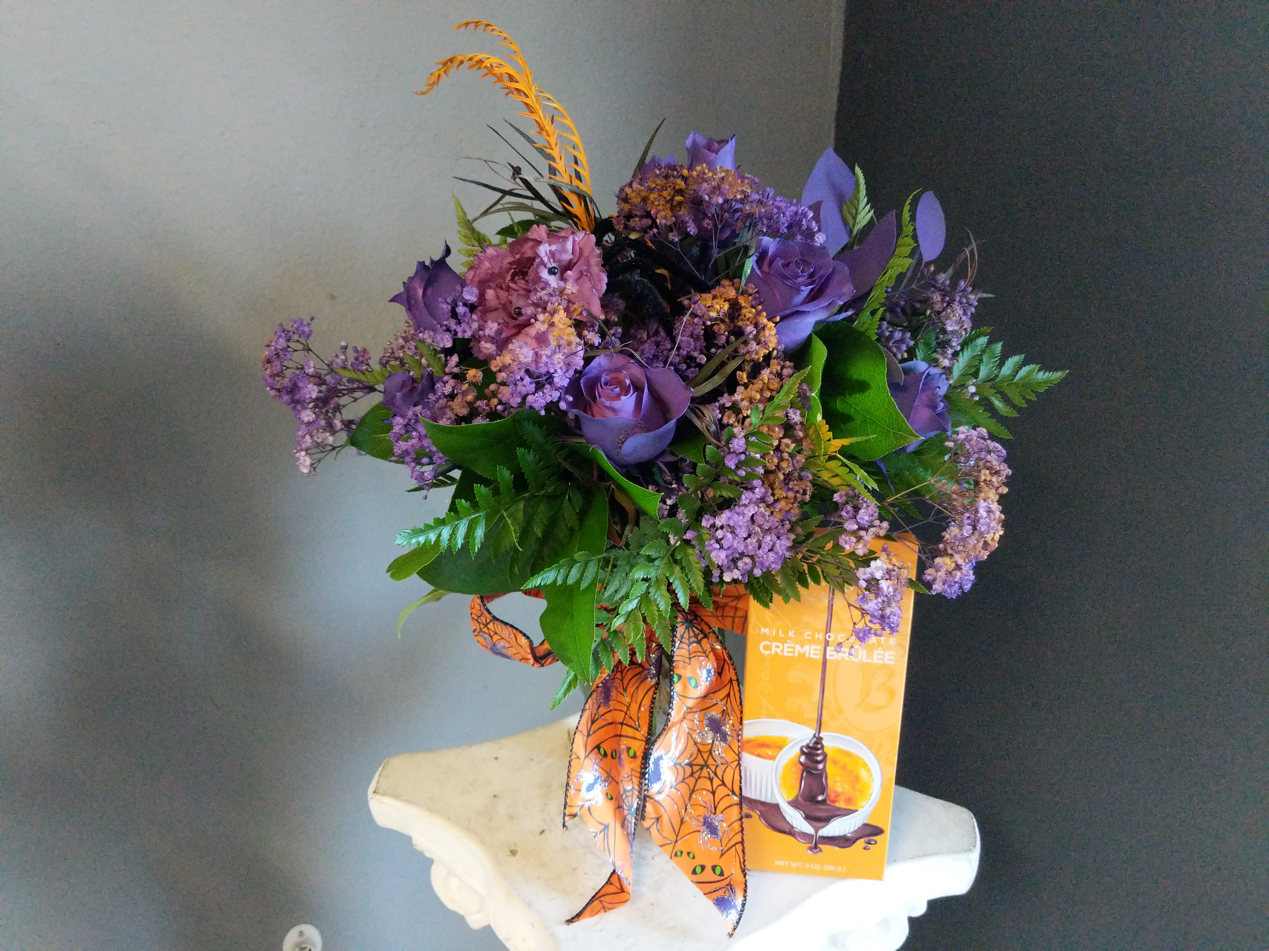 Halloween Rose Special - A dozen of our roses with orange baby's breath and a festive ribbon. Spray paint used. Comes with a Creme brulee chocolate bar! 