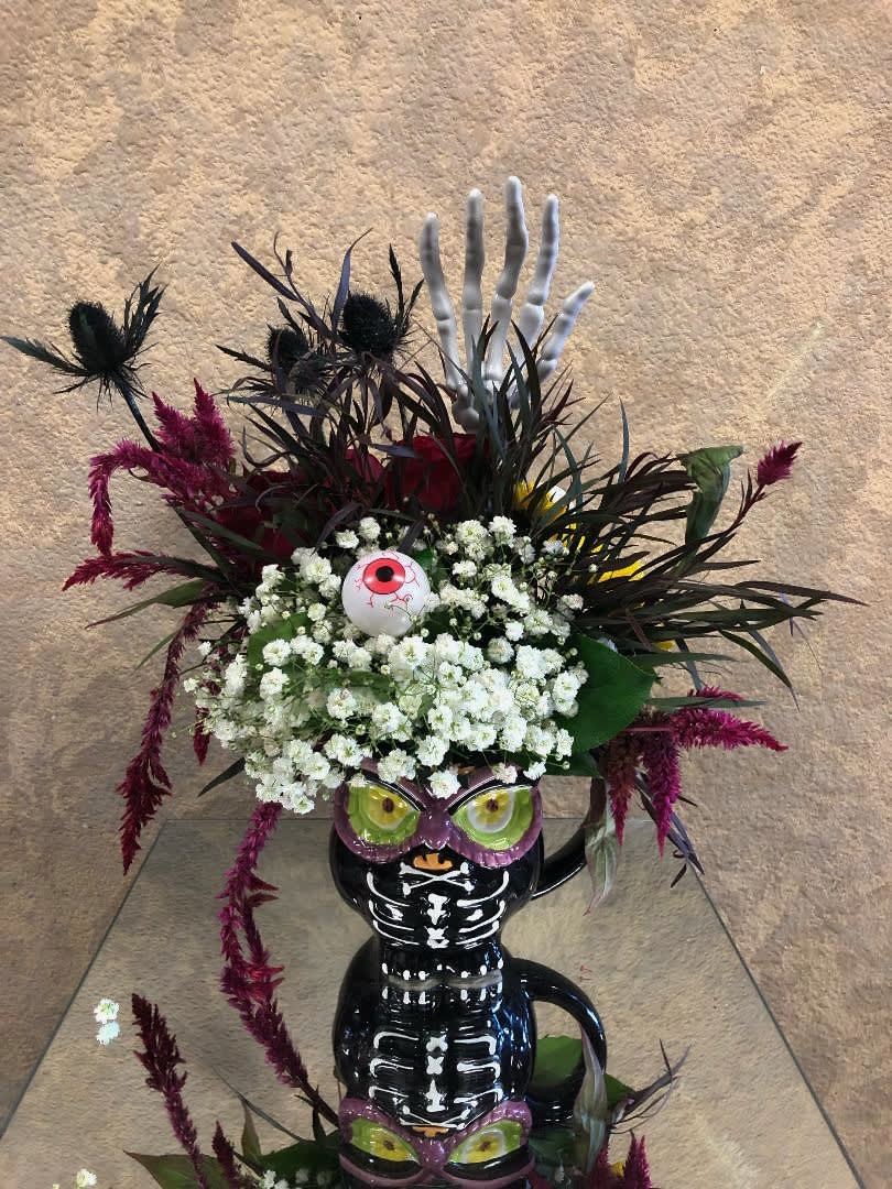 El Brujo - Spooky, Fun, Red Roses, Amaranthus, Daisies, Carnations, Baby Breath, and Eucalyptus in an owl cup with eyes and eyes.