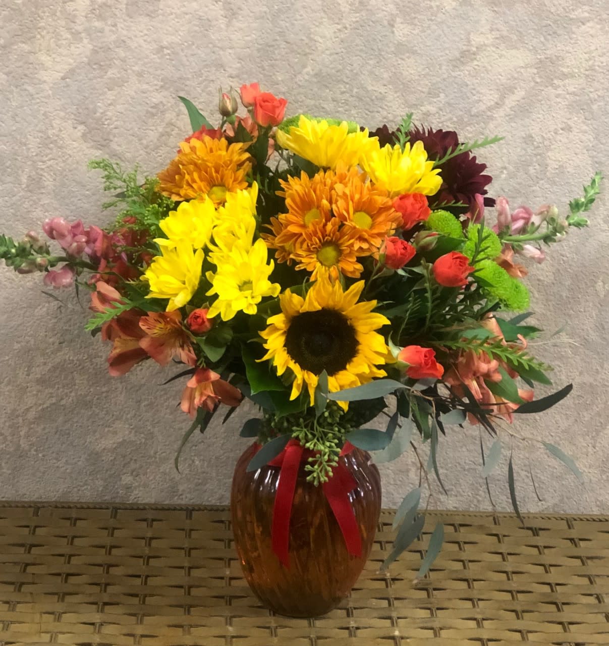 Happy Friendsgiving SPECIAL Happy Friendsgiving SPECIAL - Type of Flowers: Fall Daisies, Orange Lilies, Orange Snapdragon, Sunflowers, Alstroemerias, Green Buttons, and Yellow Daisies in an amber color vase. Availability: All year round Substitute Available: Yes Design View: Symmetric Front Facing View Photo shown: Regular
