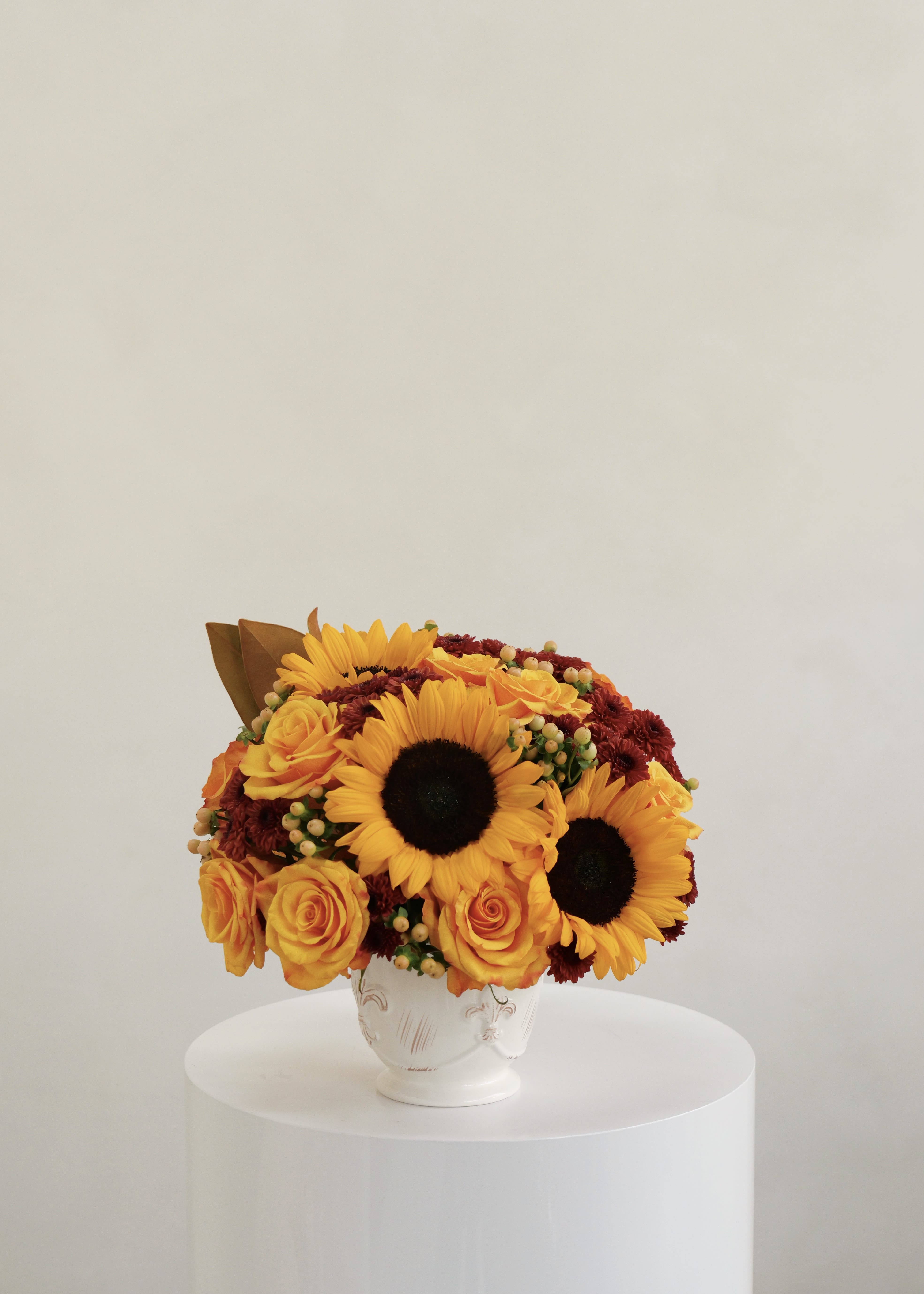 Helena Helena - A graceful blend of sunflowers and roses arranged with soft natural tones. "Helena" captures gentle warmth and refined elegance, adding a touch of sunshine wherever it’s placed.