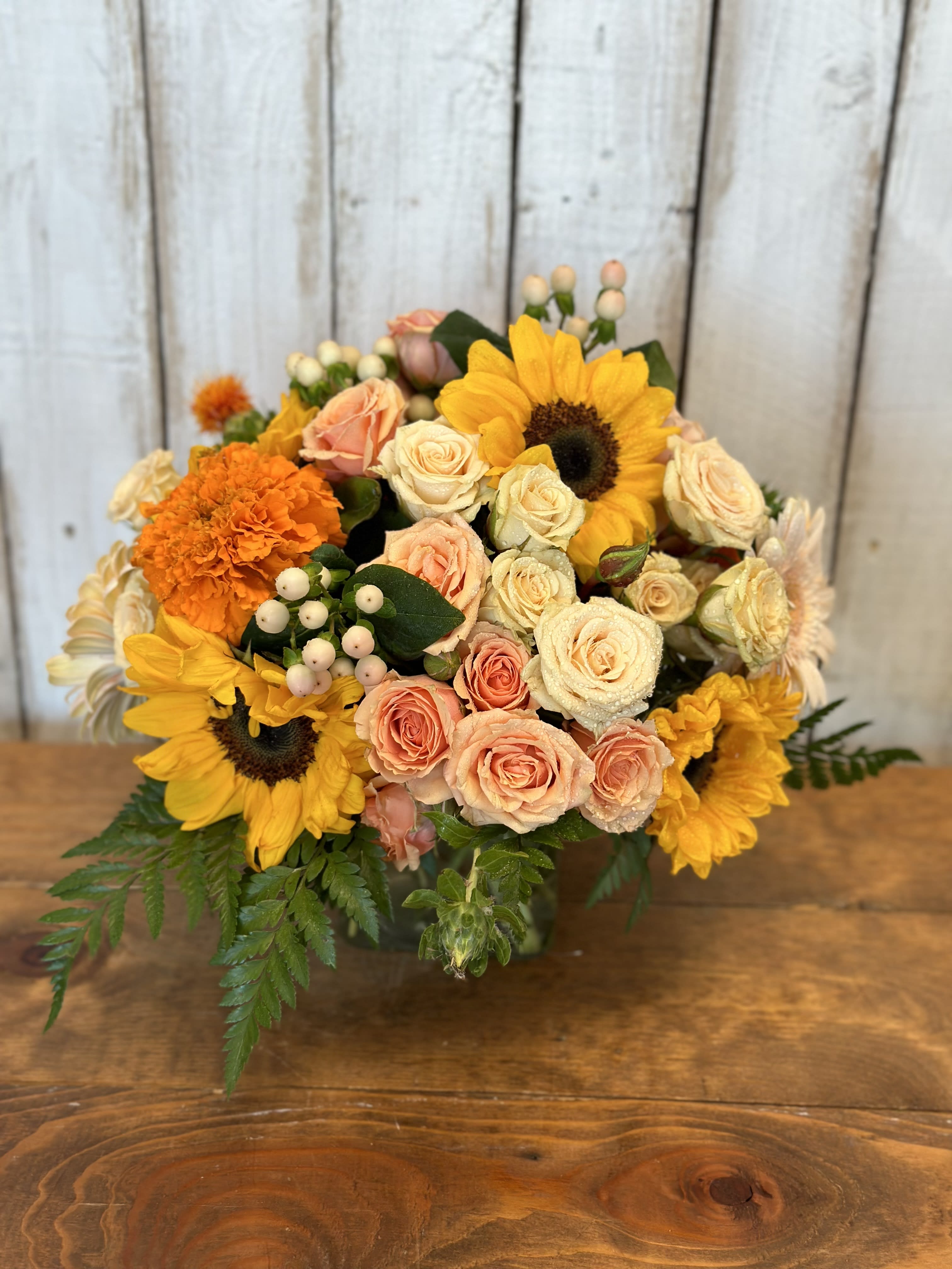 pantone color of the year - Peach Fuzz is here Pantone color of the year absolutely beautiful arrangement along with   bright florals of  sunflowers roses spray roses and more 