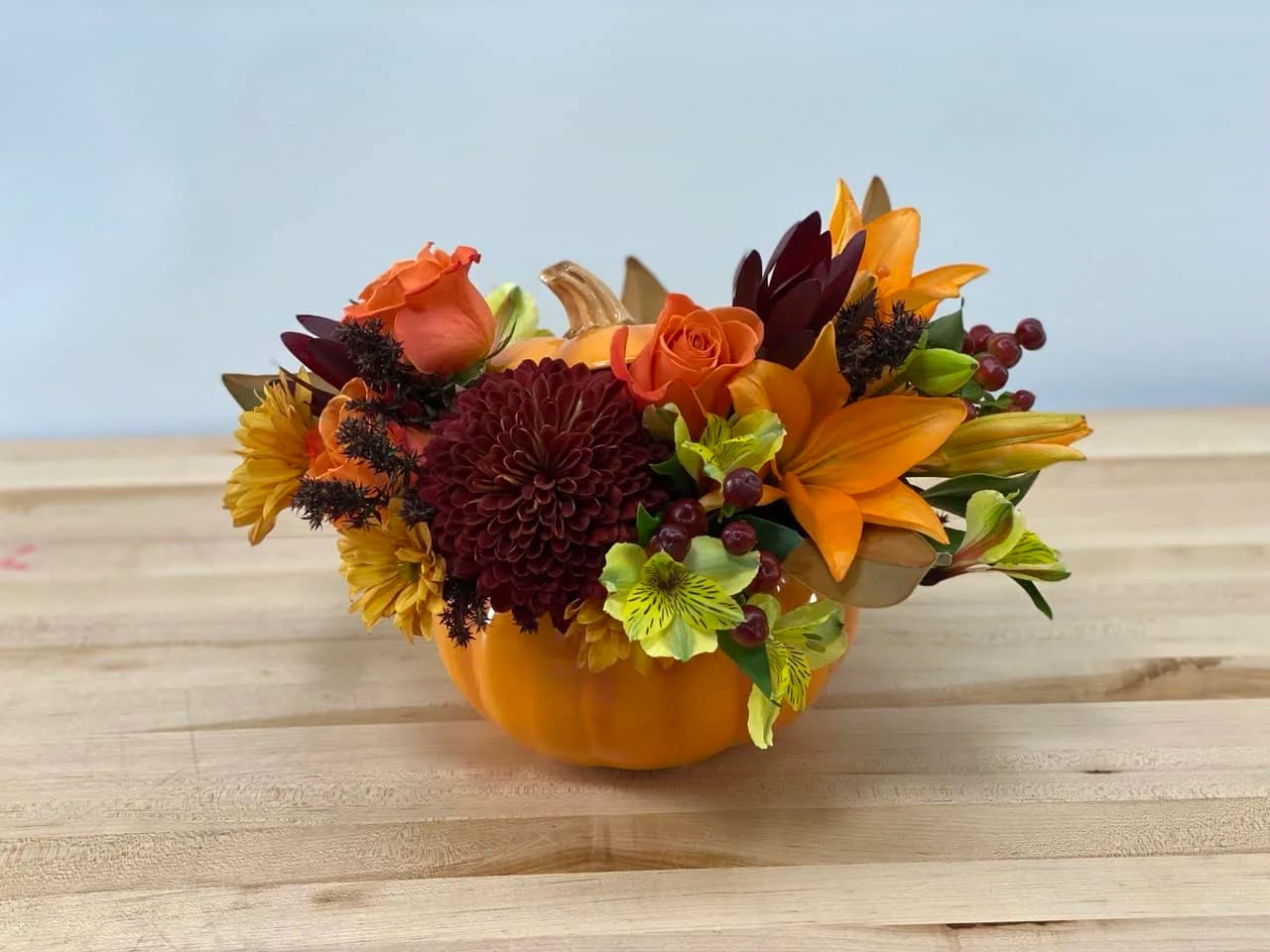 Happy Harvest - A combination of fall colors in a bright and beautiful, high quality ceramic pumpkin makes this arrangement a unique gift to celebrate fall season.
