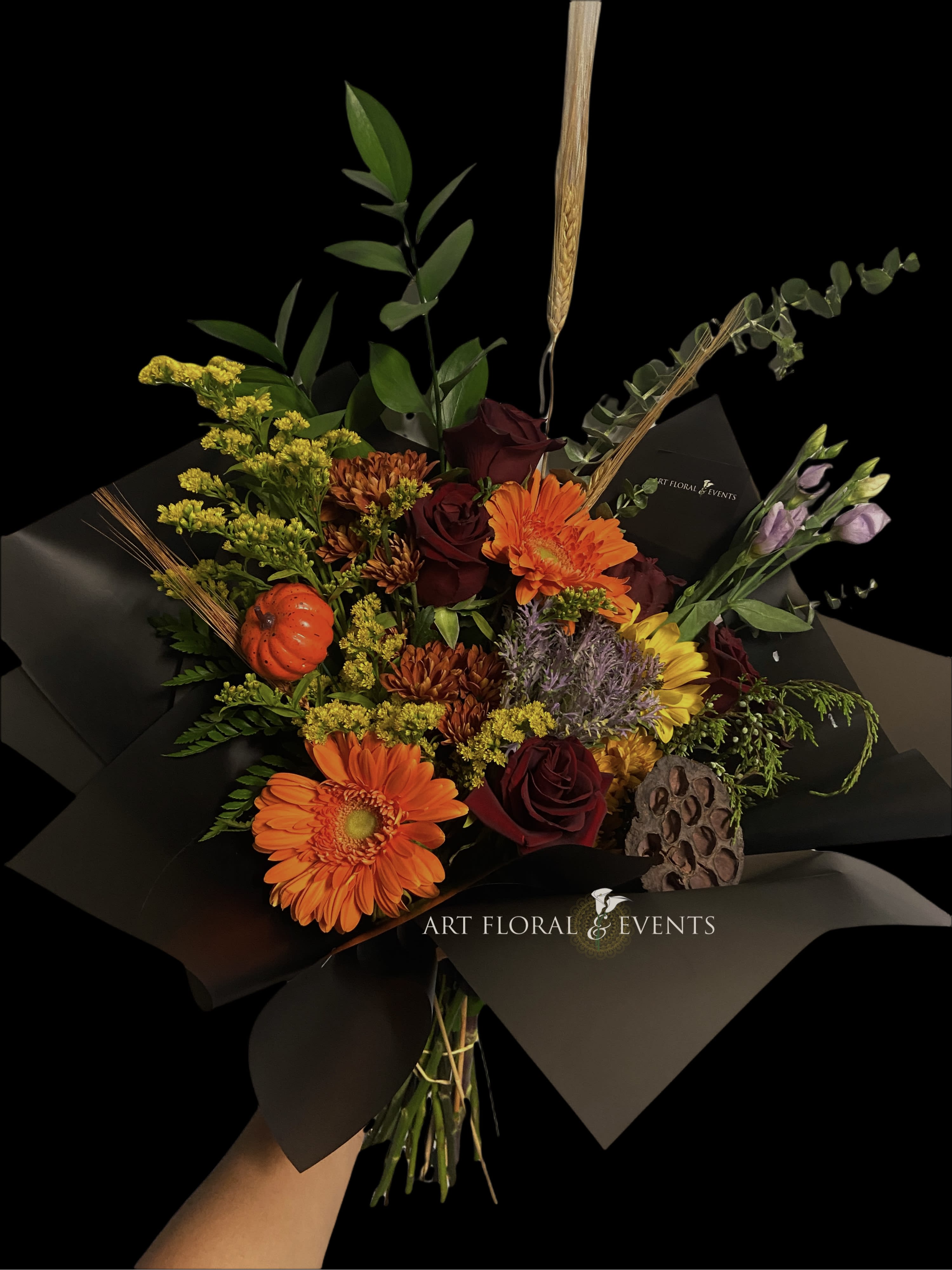 Witchful Thinking - Orange Gerberas, Red Roses, Lavendar Lisianthus, Yellow Solidago, Auburn Mums, Purple Kale, Accented with a mini pumpkin &amp; wheat!  NO VASE