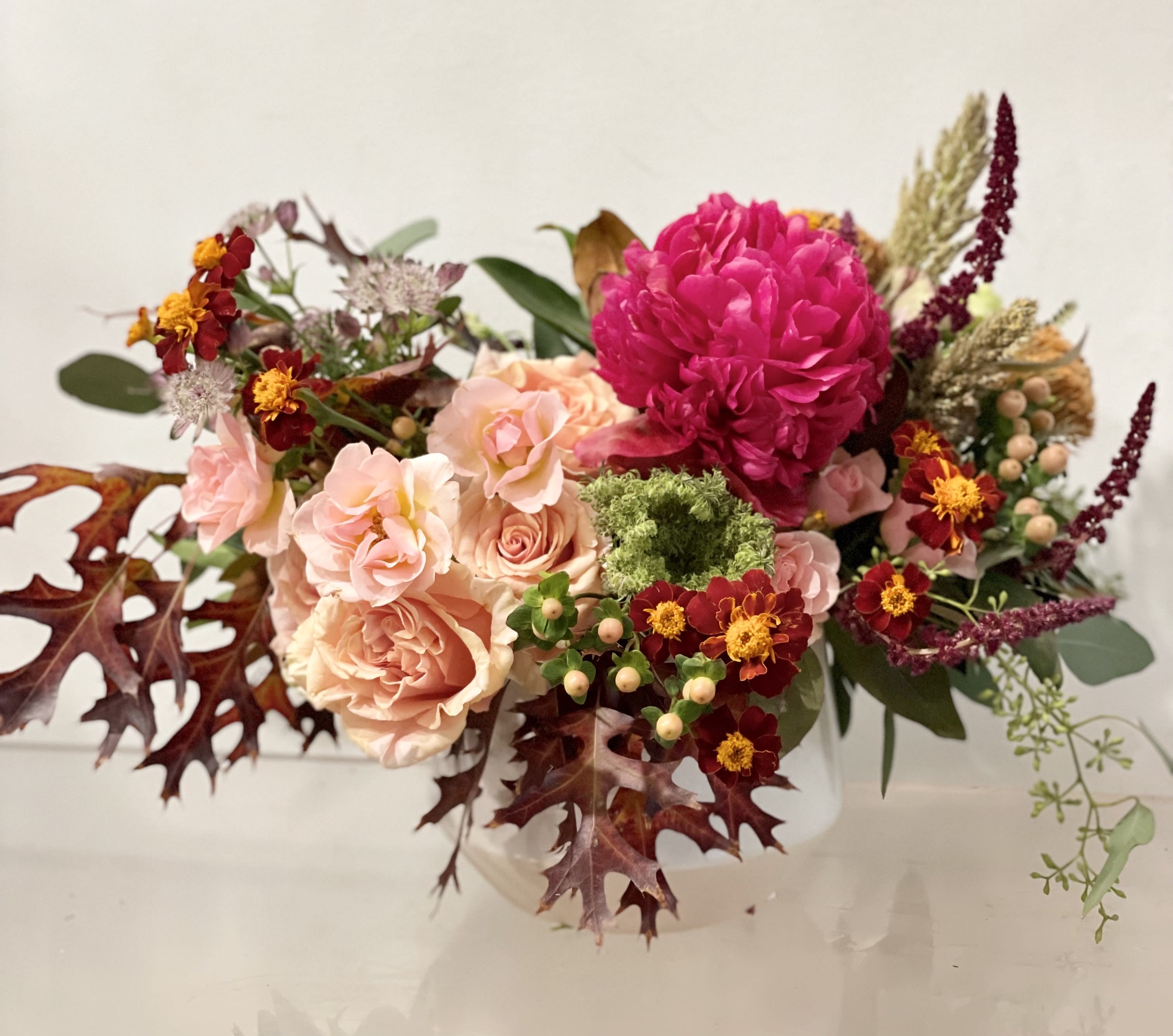 Thankful - Low arrangement of the best that fall has to offer. A garden style arrangement of texture and color. Designed in a low ceramic white vase. DESIGNERS CHOICE   Please email us with any questions you may have to info @ fleurt style com 