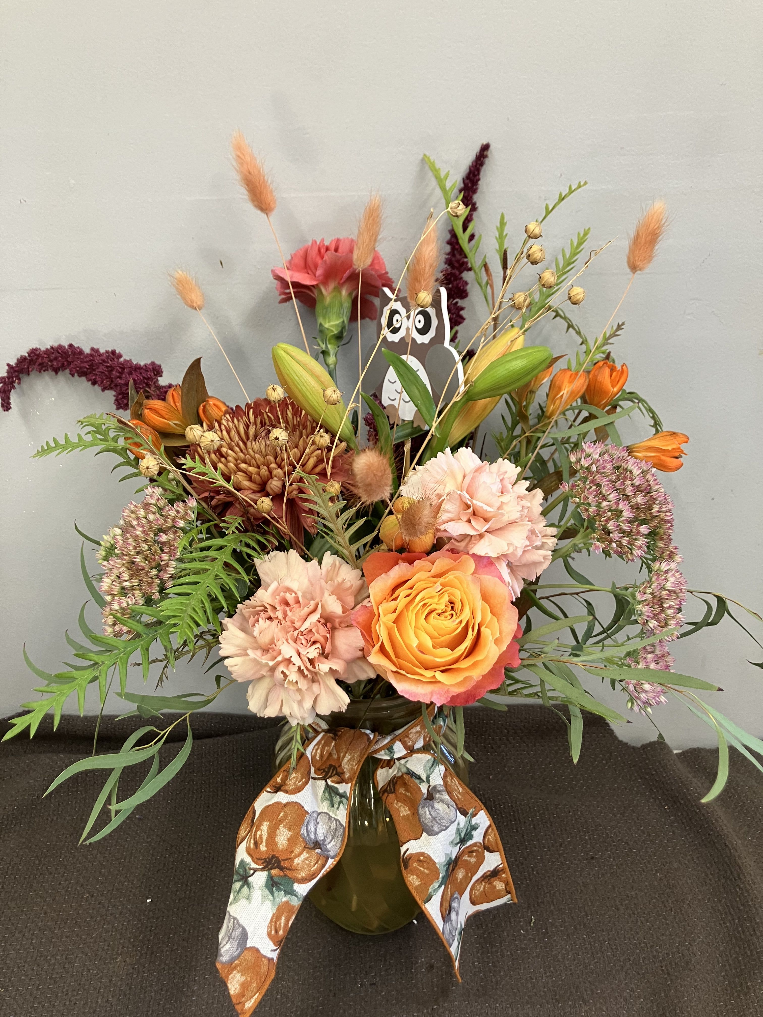 Hello Fall Hello Fall - Fall fresh flower arrangement in muted tones and fun textures! In tinted vase with ribbon!