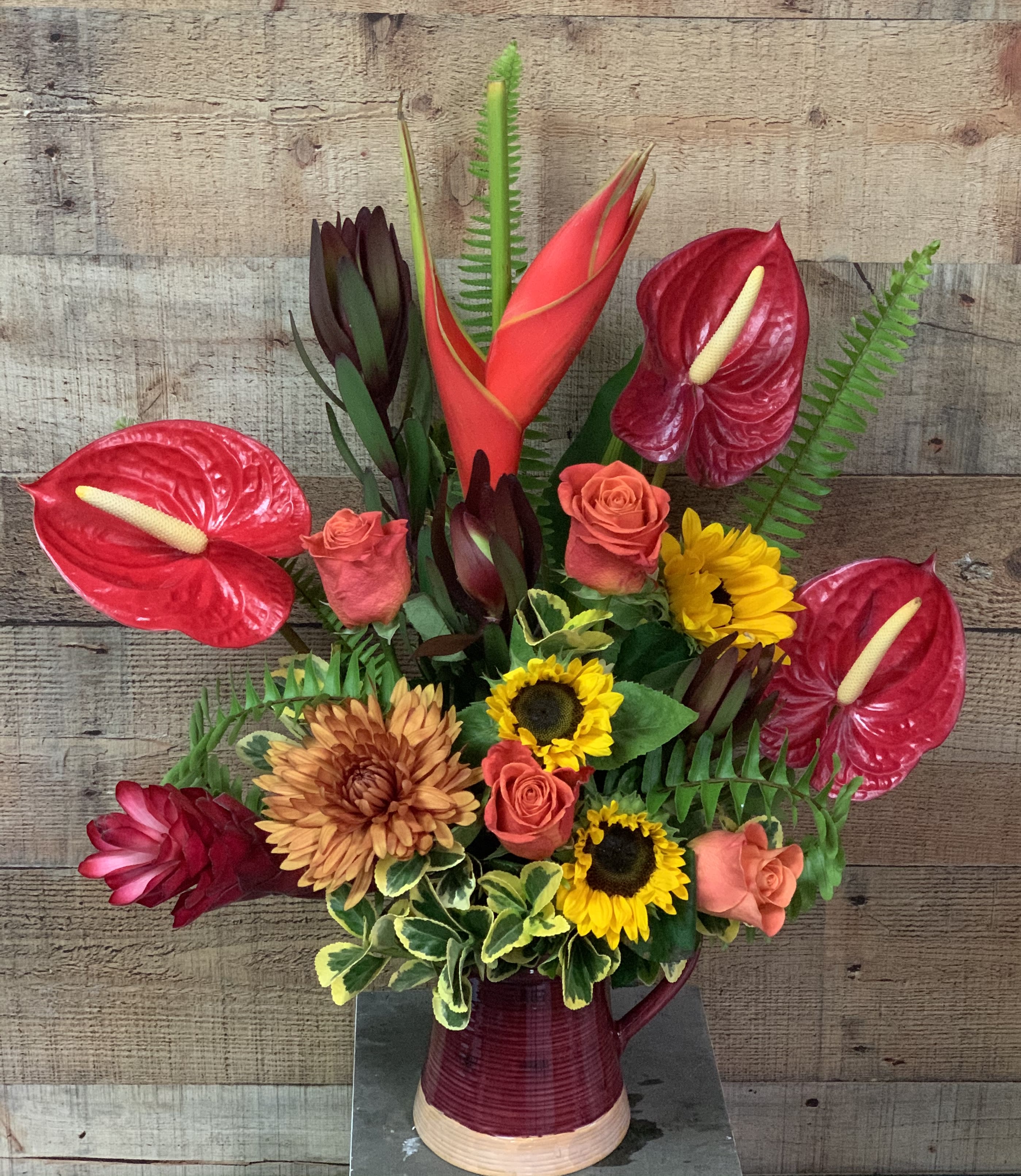 Thankful - A beautiful arrangement great for the fall season.  Tropical flowers mixed with sunflowers and roses.  Vase will vary Tropical flower availability varies. Please call to verify flowers are available if you prefer no substitutions. 