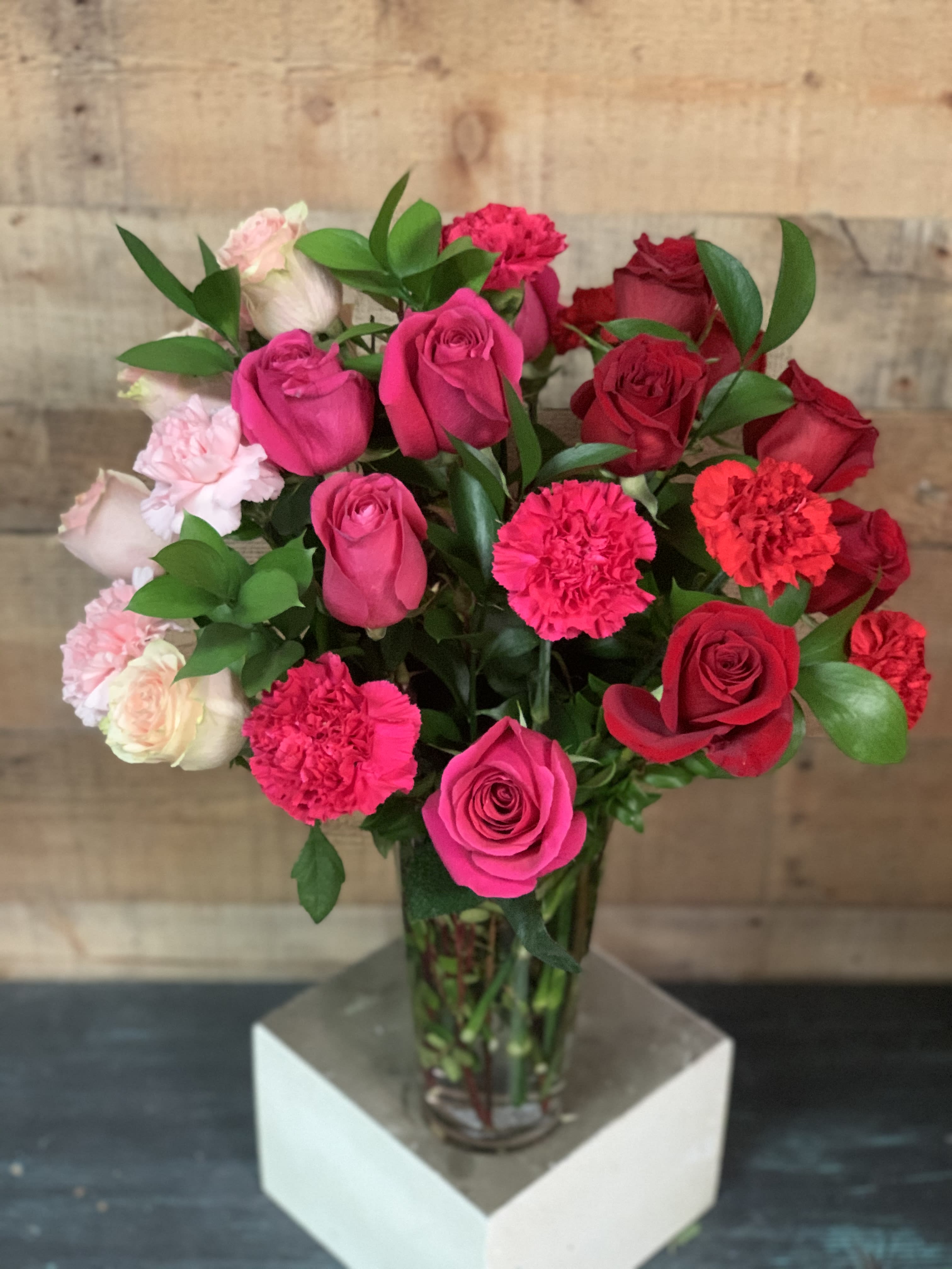 Cupid’s Bouquet Cupid’s Bouquet - Red, hot pink, and pink roses and carnations.   Regular- 18 roses 12 carnations Deluxe- All Roses 30 roses Premium- 30 Roses 12 carnations