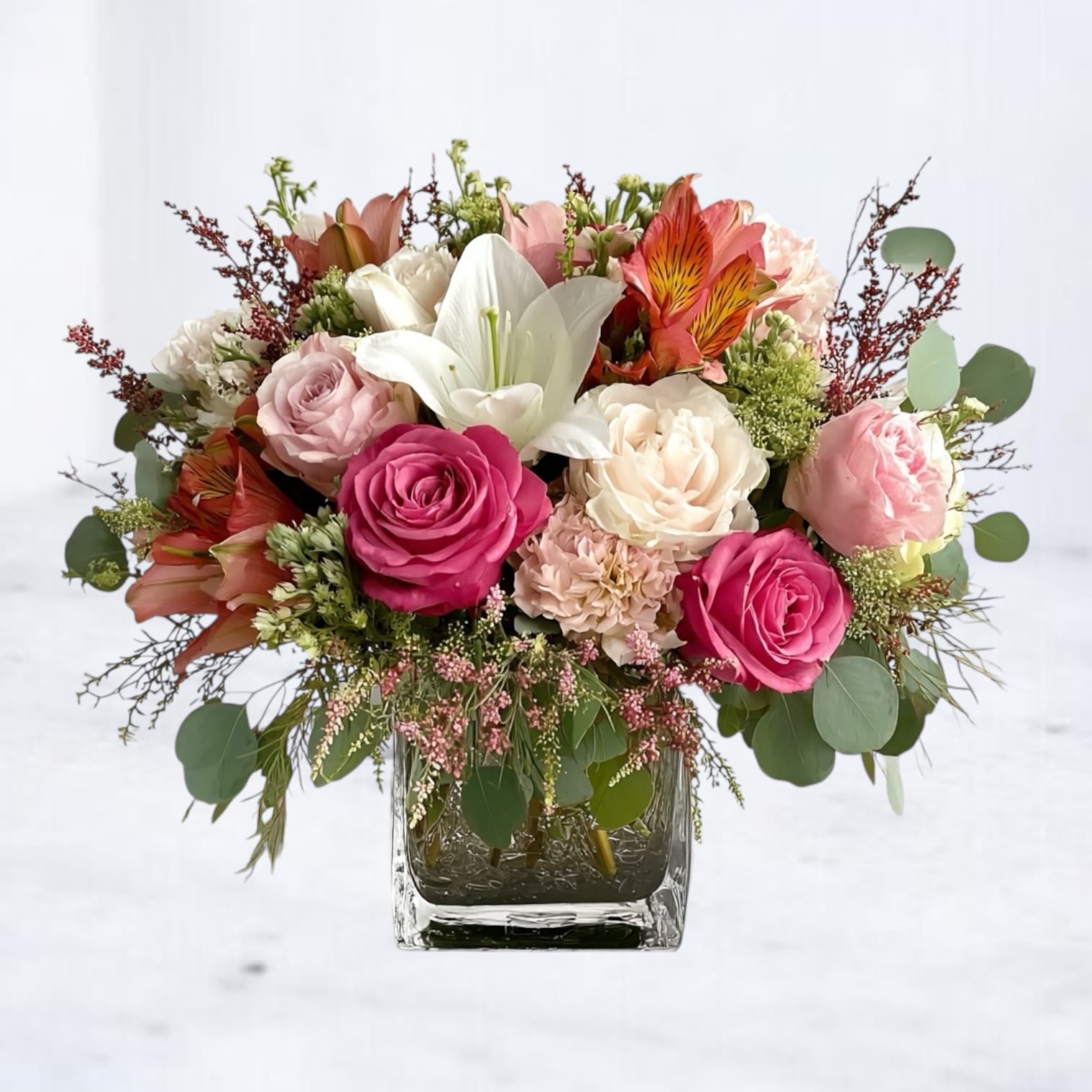 Radiant Harmony Bouquet Radiant Harmony Bouquet - Celebrate life’s special moments with our Radiant Harmony Bouquet, a vibrant arrangement that blends bold color with timeless elegance. Featuring hot pink roses, creamy white lilies, blush-toned blooms, and fiery orange alstroemeria, this design bursts with joyful energy. Handcrafted in a modern glass vase, it’s the perfect gift for birthdays, anniversaries, congratulations, or any occasion that calls for beauty and cheer. Whether delivered to a home, office, or event, this bouquet makes a stunning statement and brings warmth to every space. Our same-day flower delivery in Houston, Magnolia, The Woodlands, and surrounding areas ensures your thoughtful gift arrives fresh and full of life.