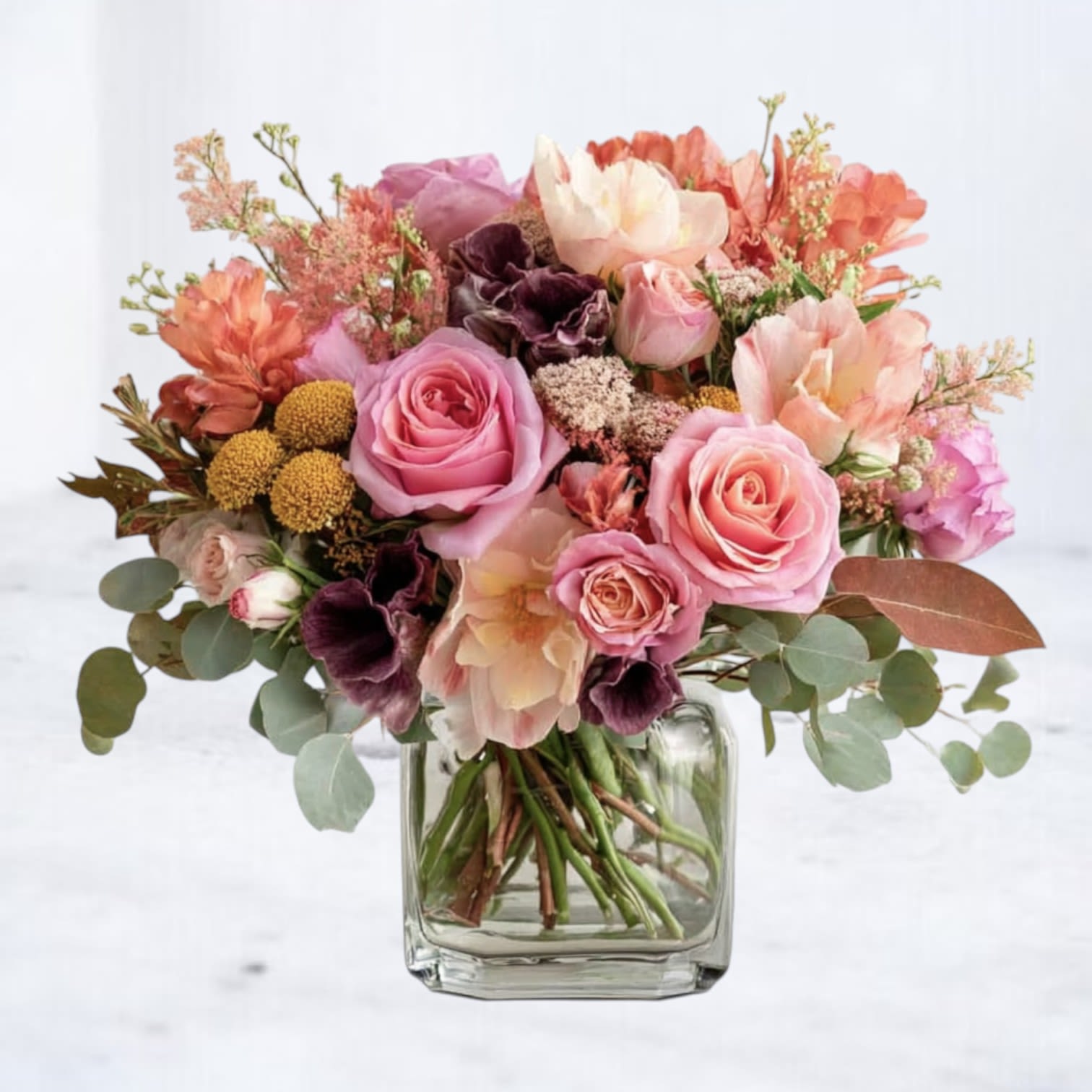 Sepia Rosefall Sepia Rosefall - Celebrate the softer side of autumn with the Sepia Rosefall, a modern fall arrangement blending blush roses, muted peach blooms, rich mauve florals, and golden accents. Designed in a clear glass vase, this bouquet captures the warmth of fall with a romantic, vintage-inspired twist. Perfect for birthdays, anniversaries, or everyday gifting, this arrangement is ideal for those who want the cozy beauty of fall without the bold, traditional palette. Each stem is thoughtfully chosen to create a look that’s both elegant and seasonally chic. Available for same-day flower delivery in Magnolia, The Woodlands, Spring, and Montgomery, TX.