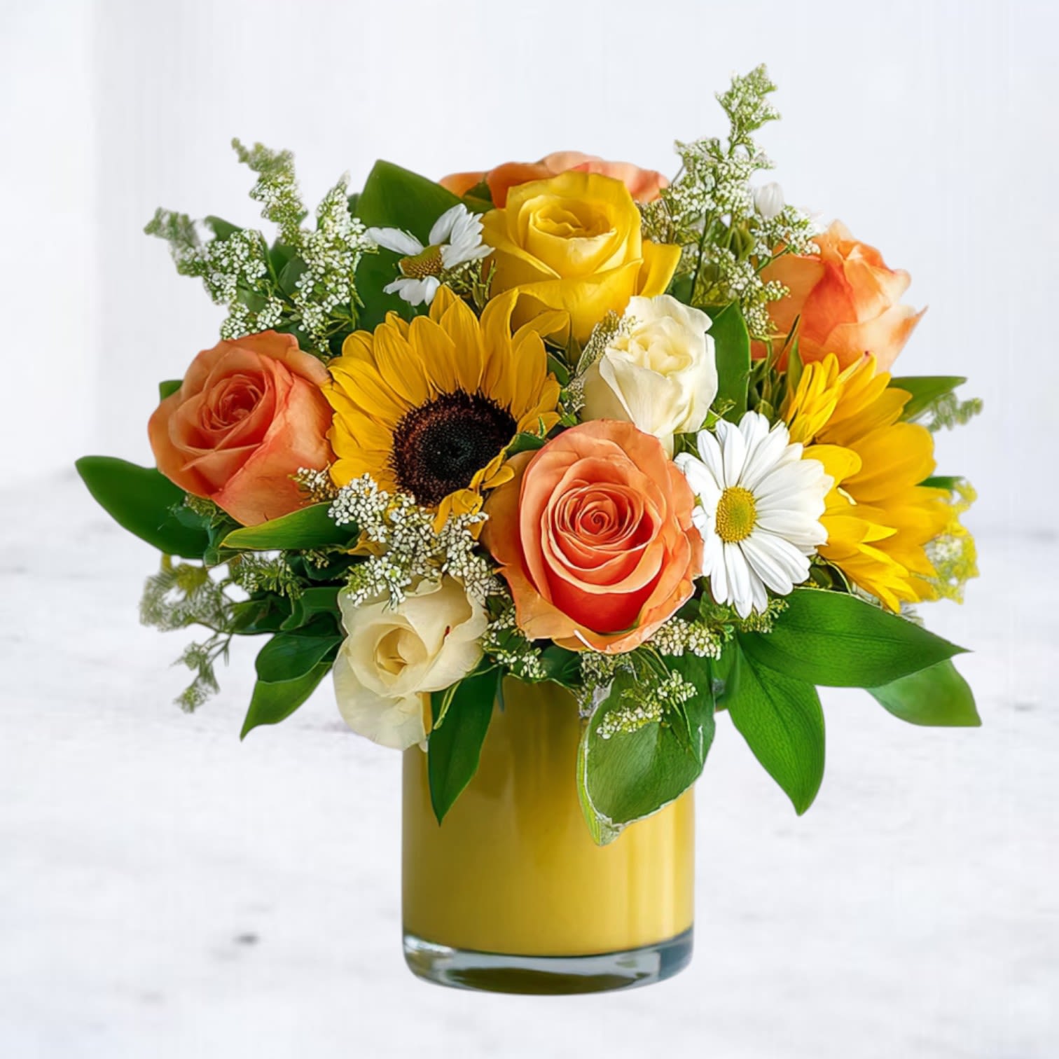 Sunny Meadow Bouquet Sunny Meadow Bouquet - Bring sunshine indoors with our Sunny Meadow Bouquet, a vibrant mix of golden sunflowers, bright yellow and orange roses, cheerful daisies, and fresh greenery. Designed in a bold yellow vase, this arrangement radiates happiness and warmth, making it the perfect choice for birthdays, get-well wishes, or simply to brighten someone’s day. Same-day flower delivery available in Magnolia, The Woodlands, Spring, and Montgomery, TX.