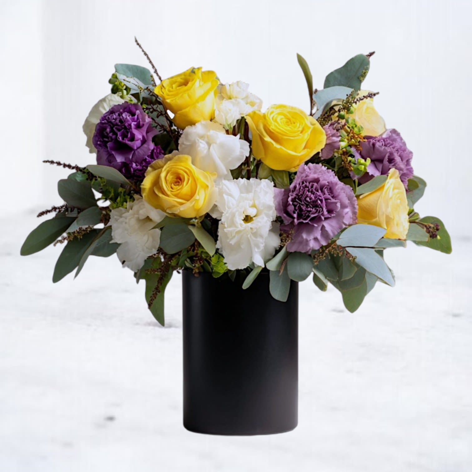 Candescent Dusk Candescent Dusk - Bright yet sophisticated, the Candescent Dusk bouquet pairs radiant yellow roses with soft lavender carnations, crisp white lisianthus, and lush eucalyptus in a sleek black vase. A modern arrangement that balances warmth and elegance, perfect for birthdays, thank-yous, or everyday luxury gifting. Available for same-day flower delivery in Magnolia, The Woodlands, Spring, and Montgomery, TX.