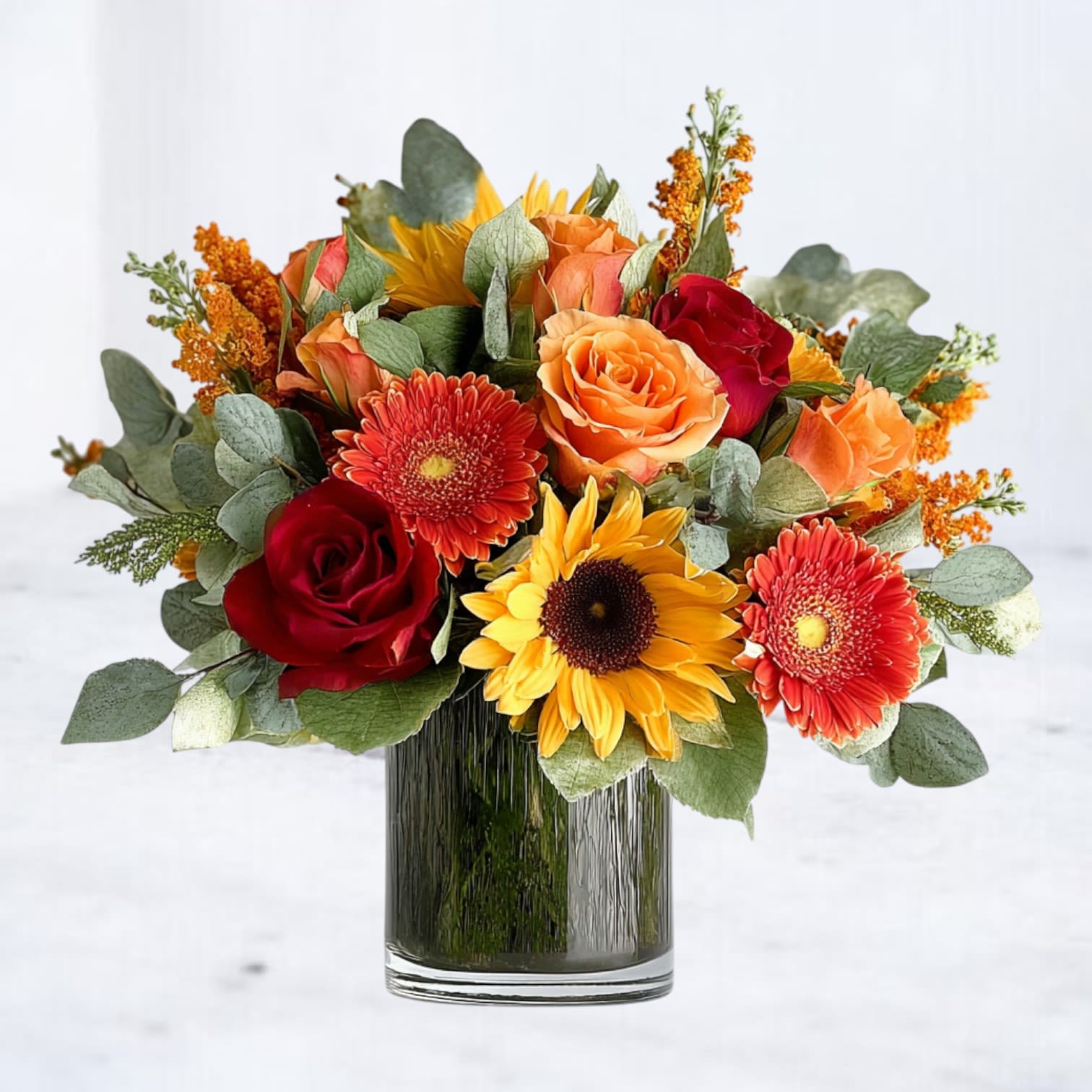 Solaris Solaris - Solaris bursts with radiant energy, blending golden sunflowers, fiery orange gerbera daisies, and velvety red roses with warm autumnal textures and lush greenery. Designed in a sleek glass vase, this arrangement captures the feeling of a glowing sunset — perfect for birthdays, fall celebrations, thank-yous, or just because. Available for same-day delivery in Magnolia, The Woodlands, Conroe, Spring, Cypress, Tomball, and throughout Houston, TX, this design is a statement piece for any occasion.