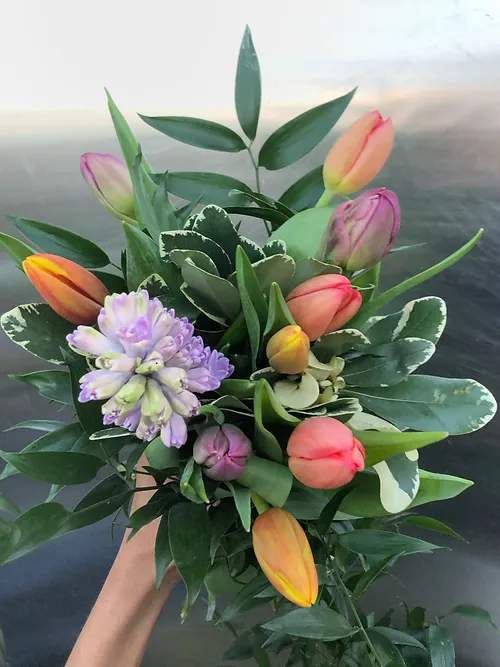Tulip Bouquet - A mixture of locally grown premium novelty and classic tulips bunched with a few stems of signature spring flowers. Each tulip bouquet is made to order and may differ slightly from those pictured.     Small: $45 (w/vase: $60)  Medium $65 (w/vase $90)  Large $80 (w/vase $115)  Bouquet will be delivered approximately as pictured.