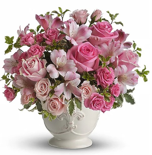 Teleflora's Pink Potpourri Bouquet - As strong as it is soft, the color pink as it is featured here creates a loving and utterly feminine tribute. Many shades of pink blossoms blend together for an effect that is beautifully subtle and sublime. A range of lovely flowers like pink roses, spray roses and alstroemeria are accented by fresh greens in the loveliest way and delivered in a beautiful French Country Pot.  