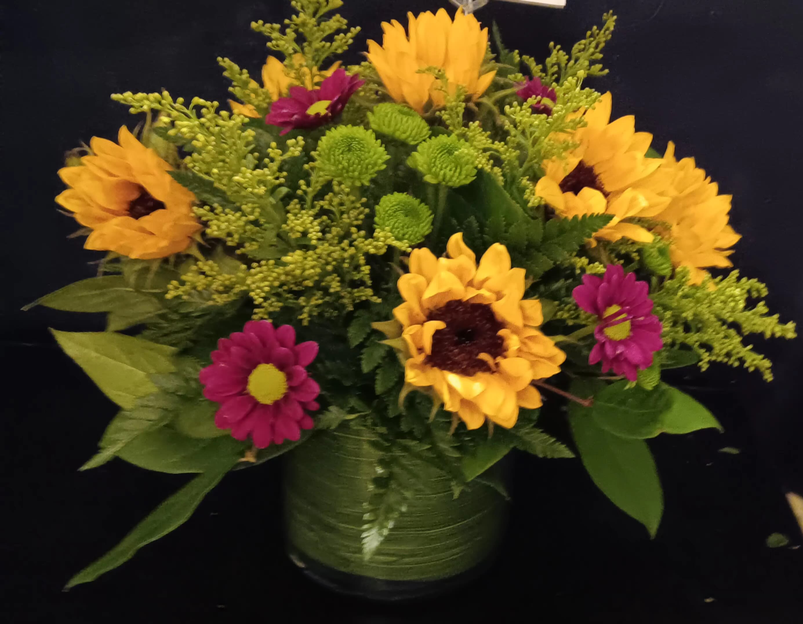 Sunflowers and more - This sunflower arrangement is accented with green buttons purple daisies 