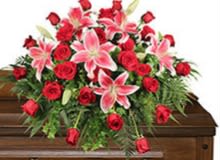 Rose and lily casket spray  - This beautiful remembrance casket spray is full of red roses  accented with oriental lilies 