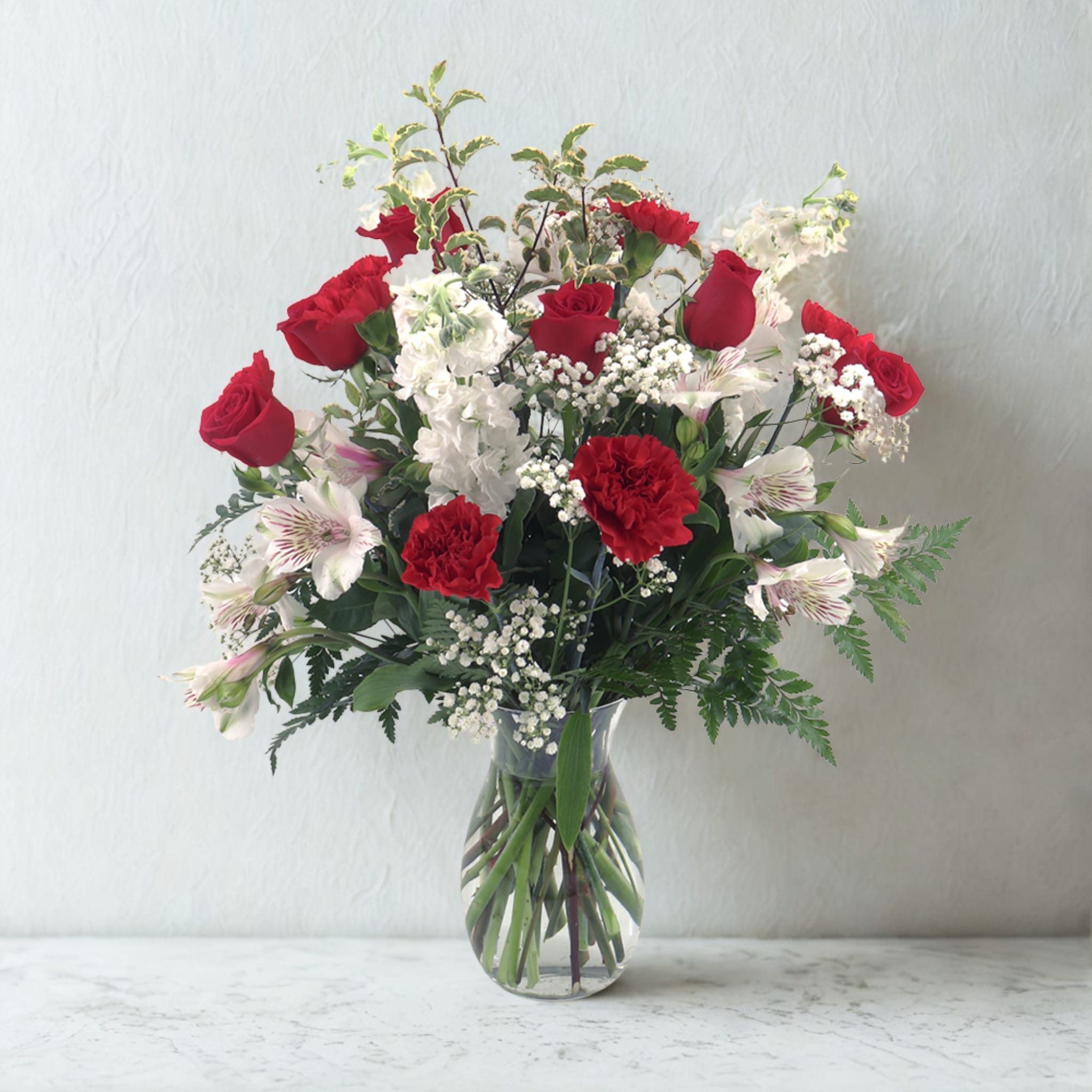 On Eagles Wings - A timeless expression of grace and peace, On Eagles Wings features a soothing blend of radiant reds and gentle whites. This classic design combines velvety red roses, soft white alstroemeria, and fragrant white stock, artfully arranged to bring comfort, hope, and quiet strength. Perfect for lifting spirits, celebrating life’s enduring beauty, or simply offering a heartfelt touch of care.  Thoughtfully crafted by the floral artisans at Birch &amp; Blossom, where every bloom is designed to bring warmth and comfort to the heart.