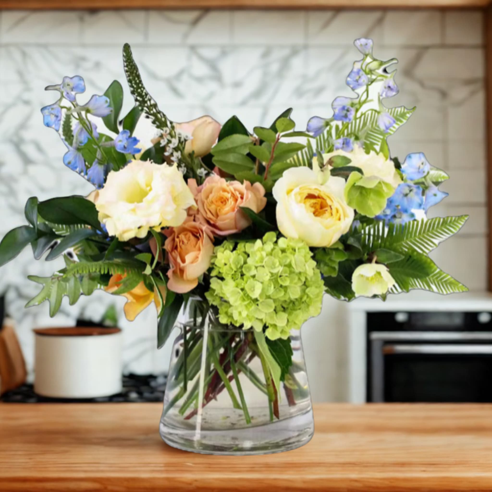 Moss &amp; Moonlight  - Inspired by the quiet magic of moonlit waters, Moss &amp; Moonlight captures the calm and wonder of an evening by the river. Cool tones of green hydrangea mingle with the soft blues of delphinium, feathery astilbe, elegant lisianthus, and delicate spray roses to create a serene, nature-touched design. Like the reflection of moonlight on still water, this arrangement evokes peace, depth, and gentle beauty.  Lovingly crafted by the floral artists at Birch &amp; Blossom, where every stem is placed with intention and a touch of natural poetry.